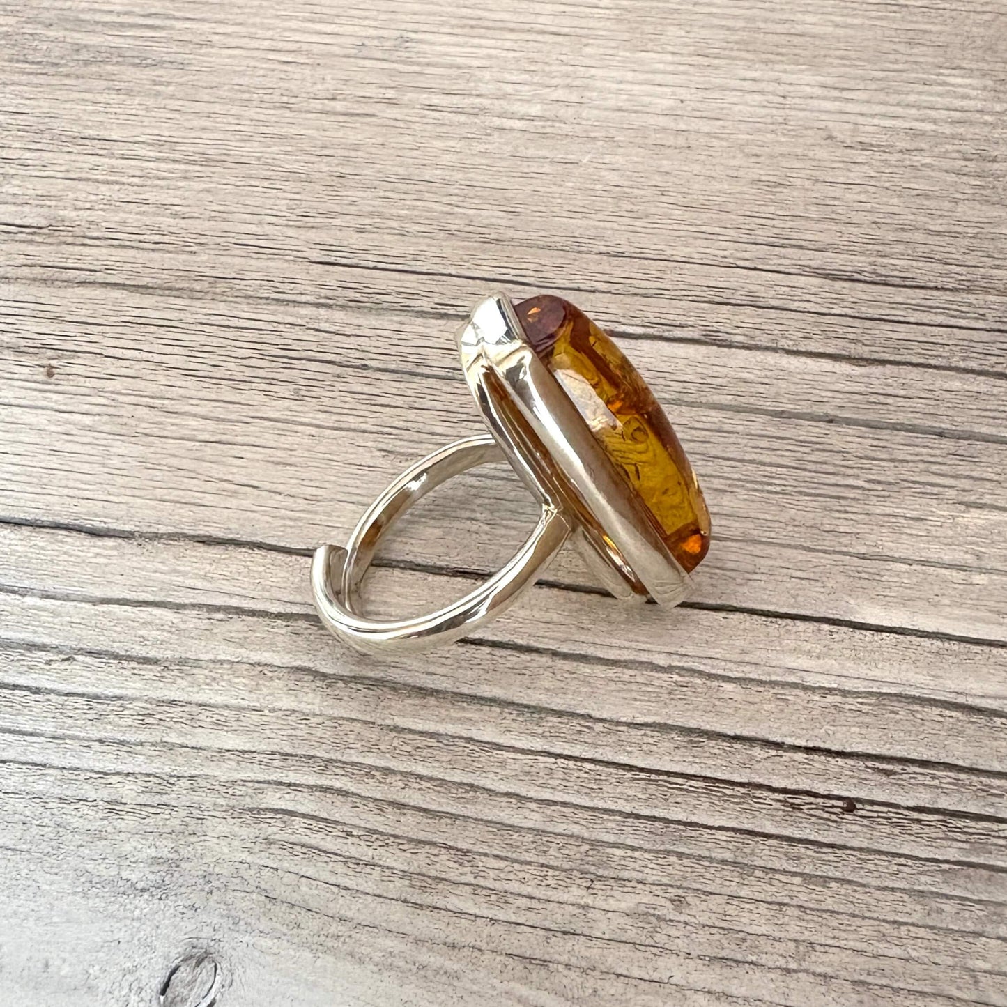 side picture of a sterling silver and rectangular amber adjustable ring