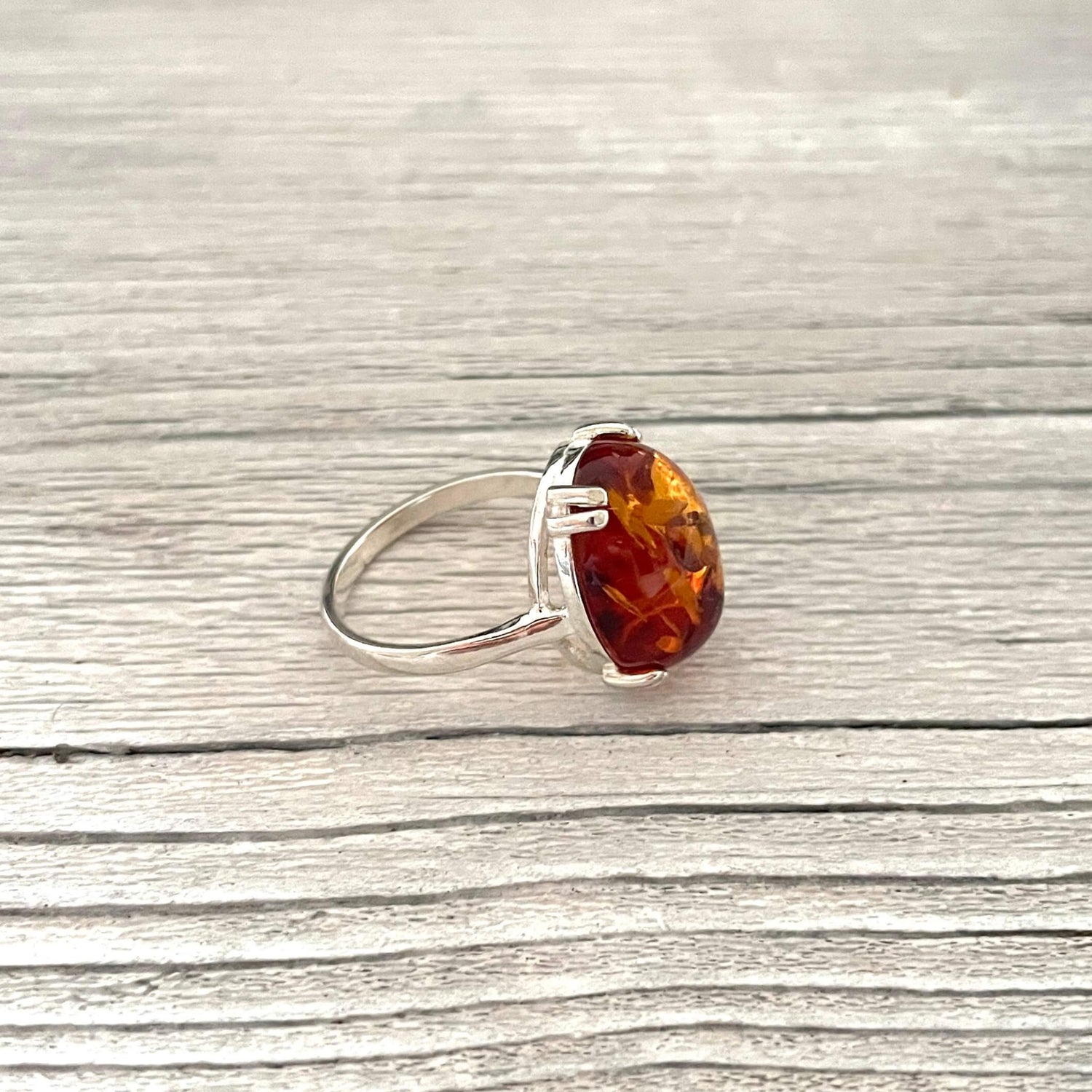 cognac coloured oval shaped amber ring set in sterling silver