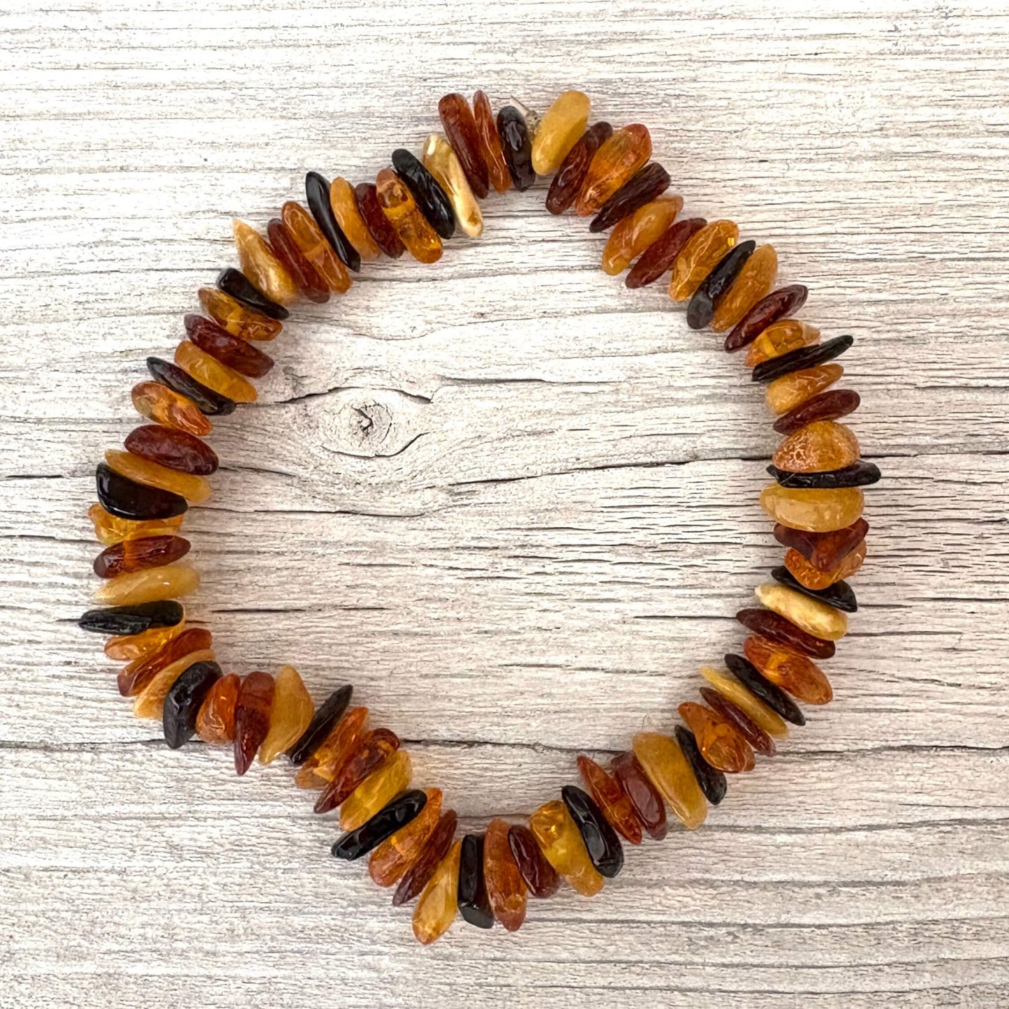 beaded amber bracelet on wooden urface