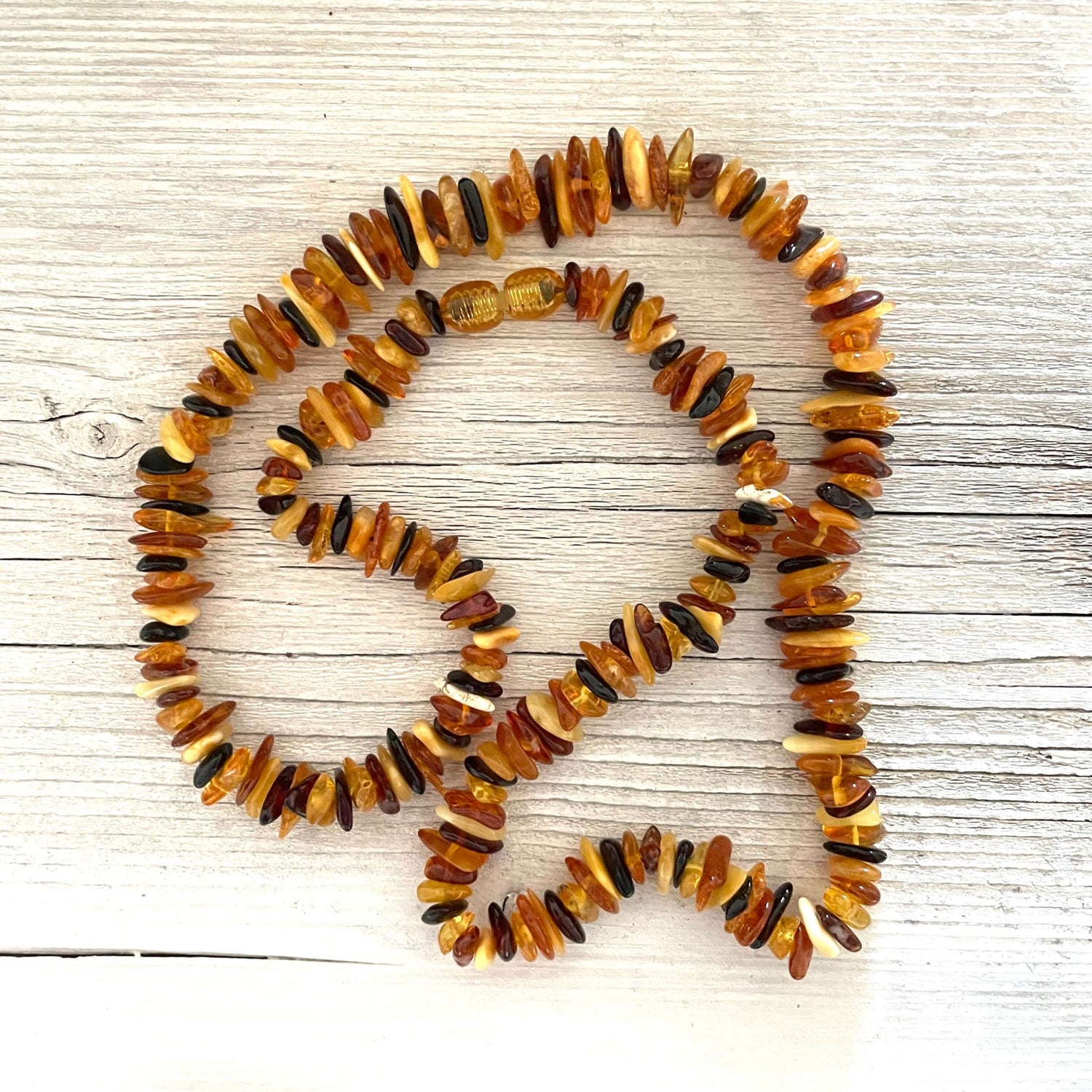polished beaded mixed coloured amber necklace with screw clasp