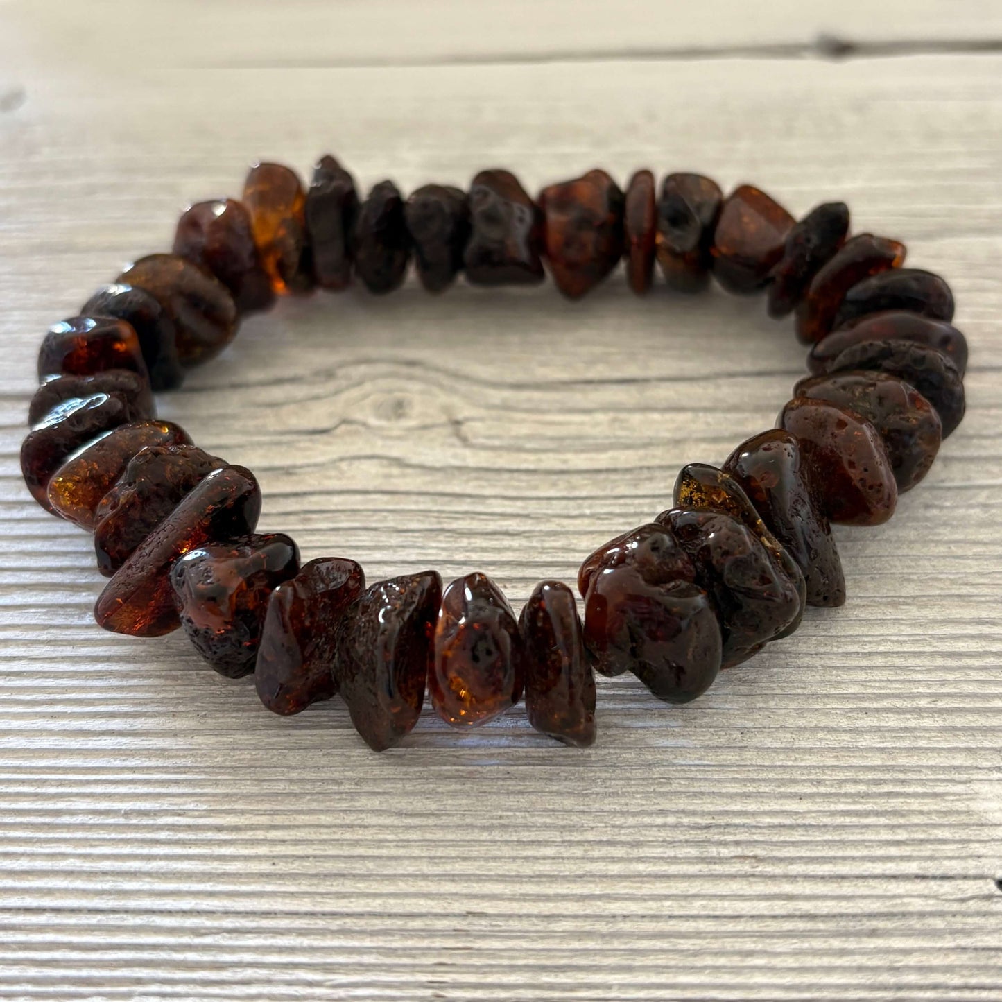Bracelet made of amber beads on a textured surface