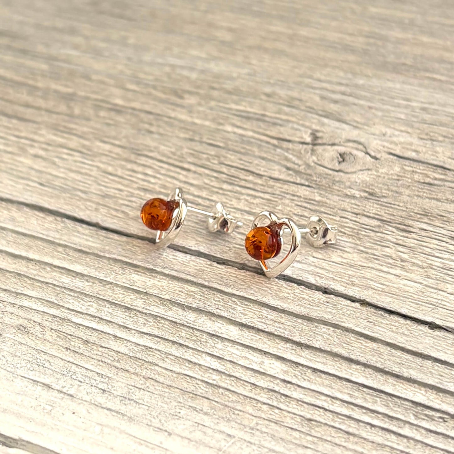 sterling silver love heart shaped stud earrings with cognac amber stone right side