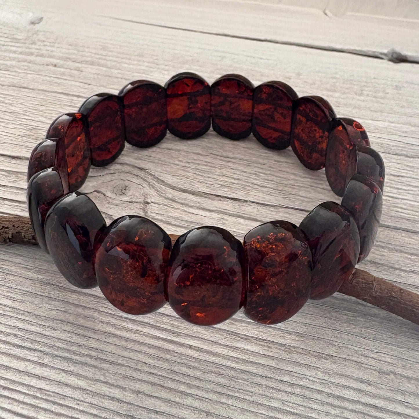Beaded bracelet with brown beads on a wooden surface