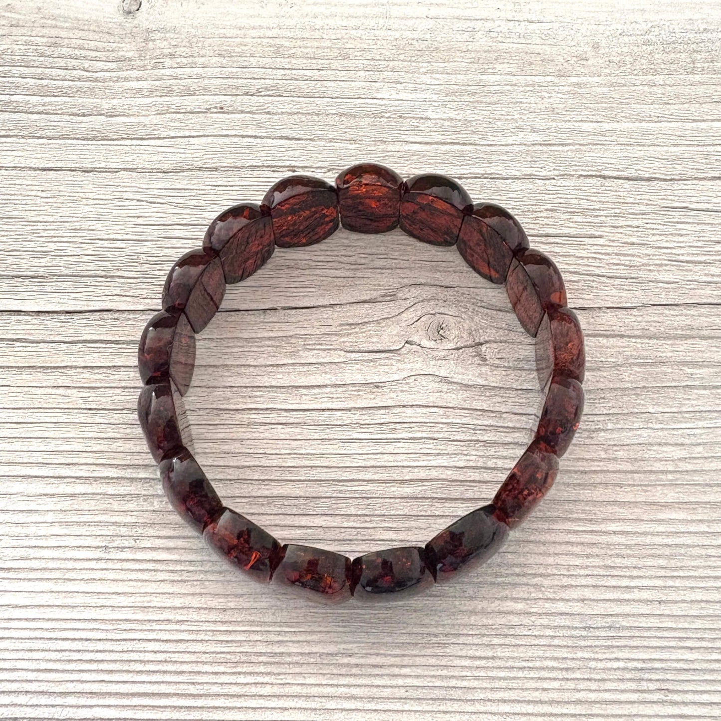 Bracelet with cognac amber stones on a wooden surface