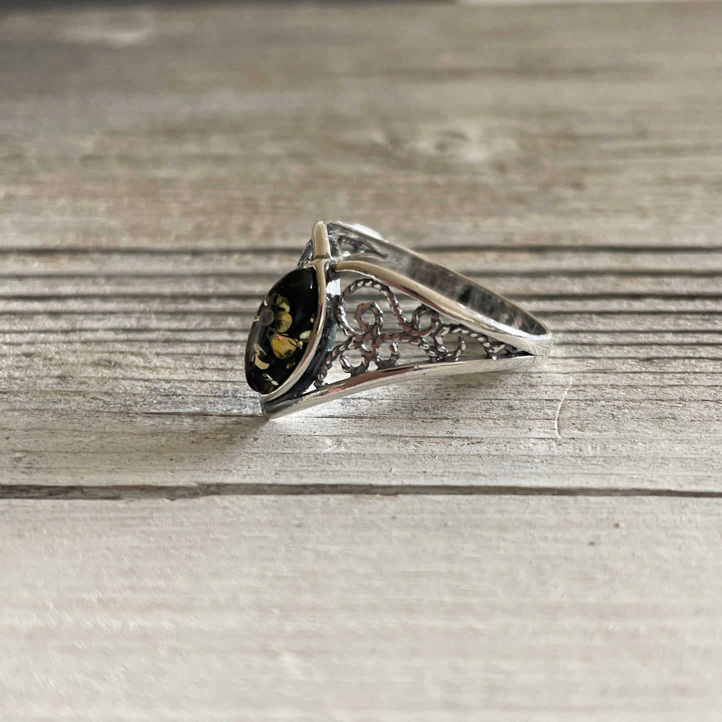 oval shaped green amber ring set in sterling silver left side