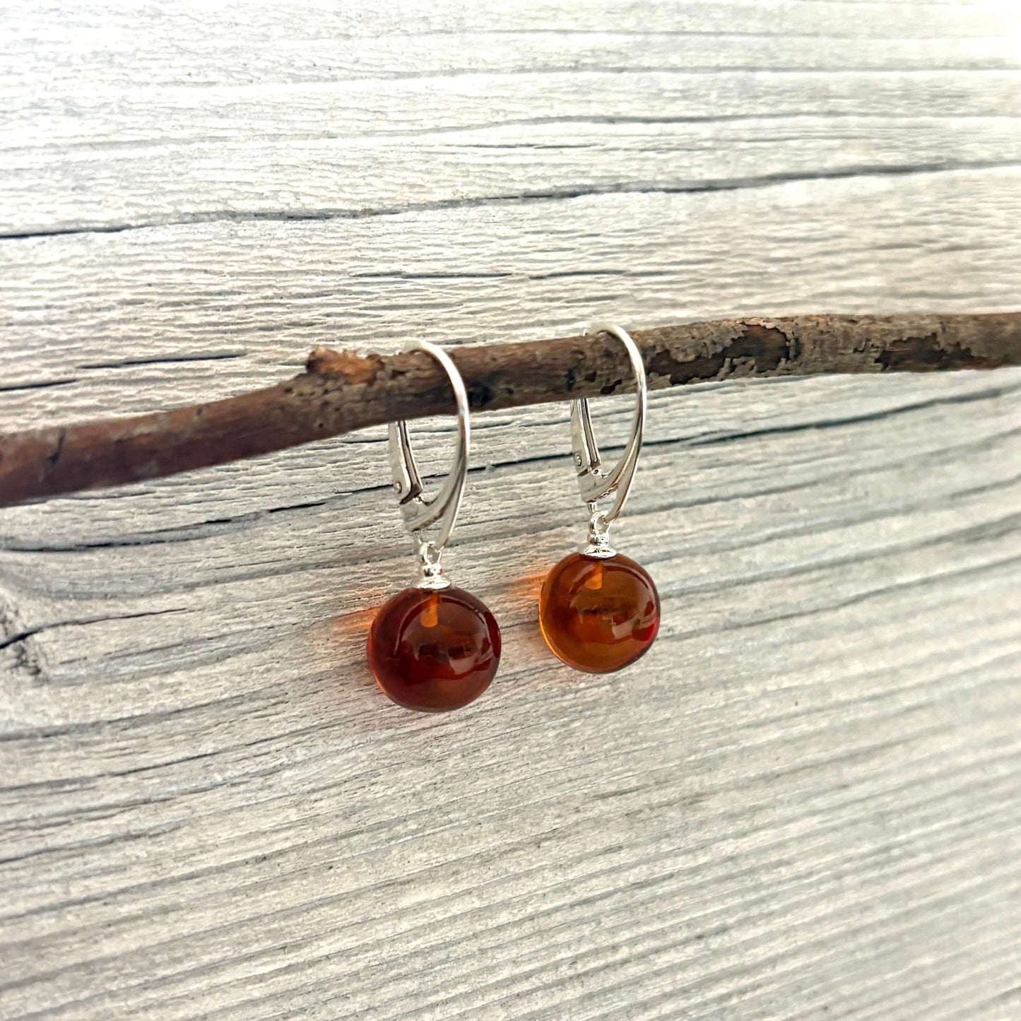 Amber drop earrings on a wooden branch