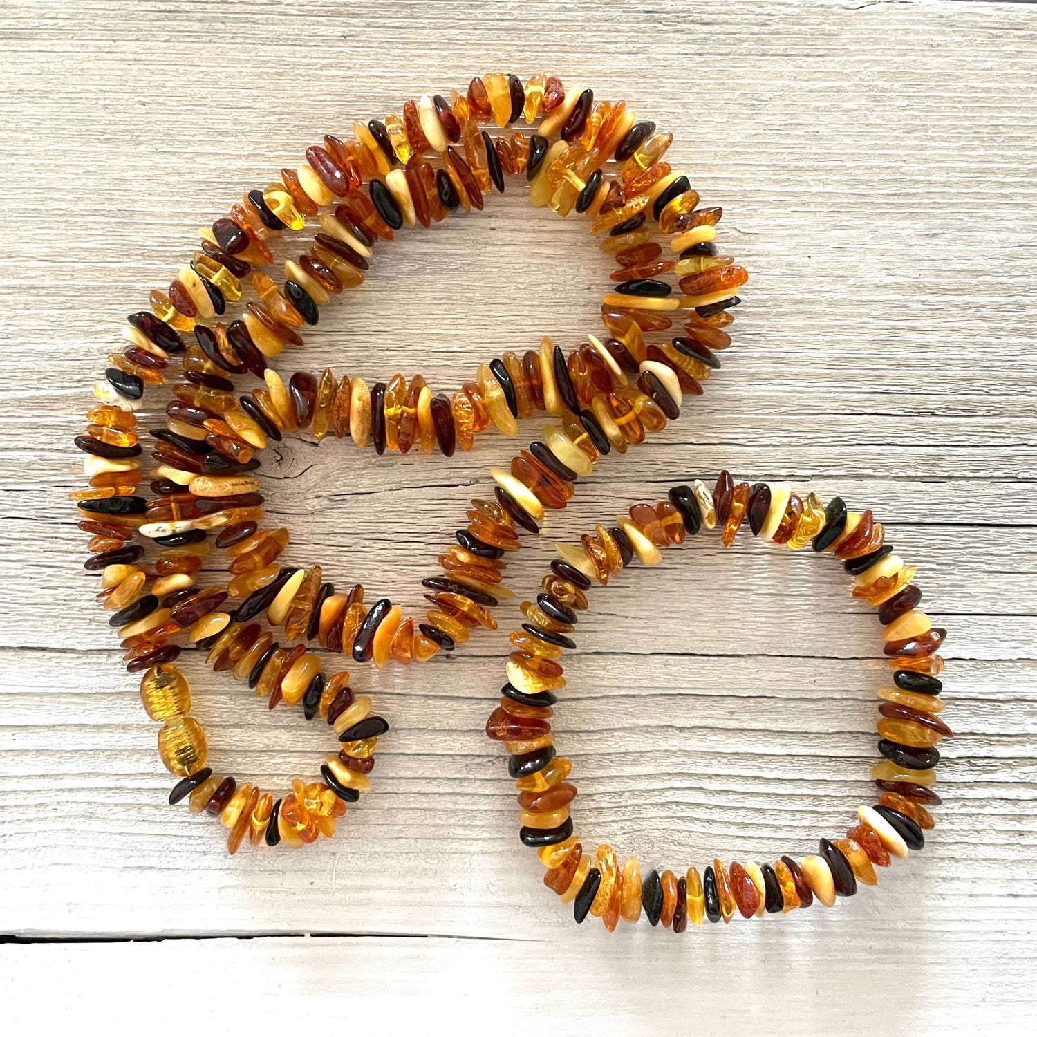 matching polished amber mixed coloured beaded necklace and bracelet