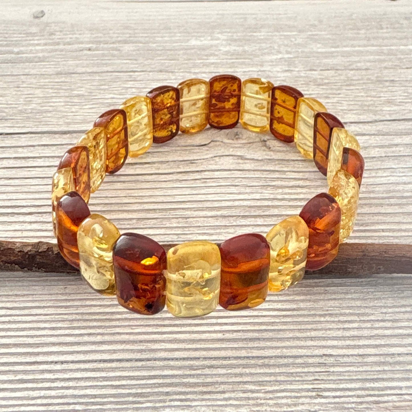 Amber beaded bracelet on a wooden surface