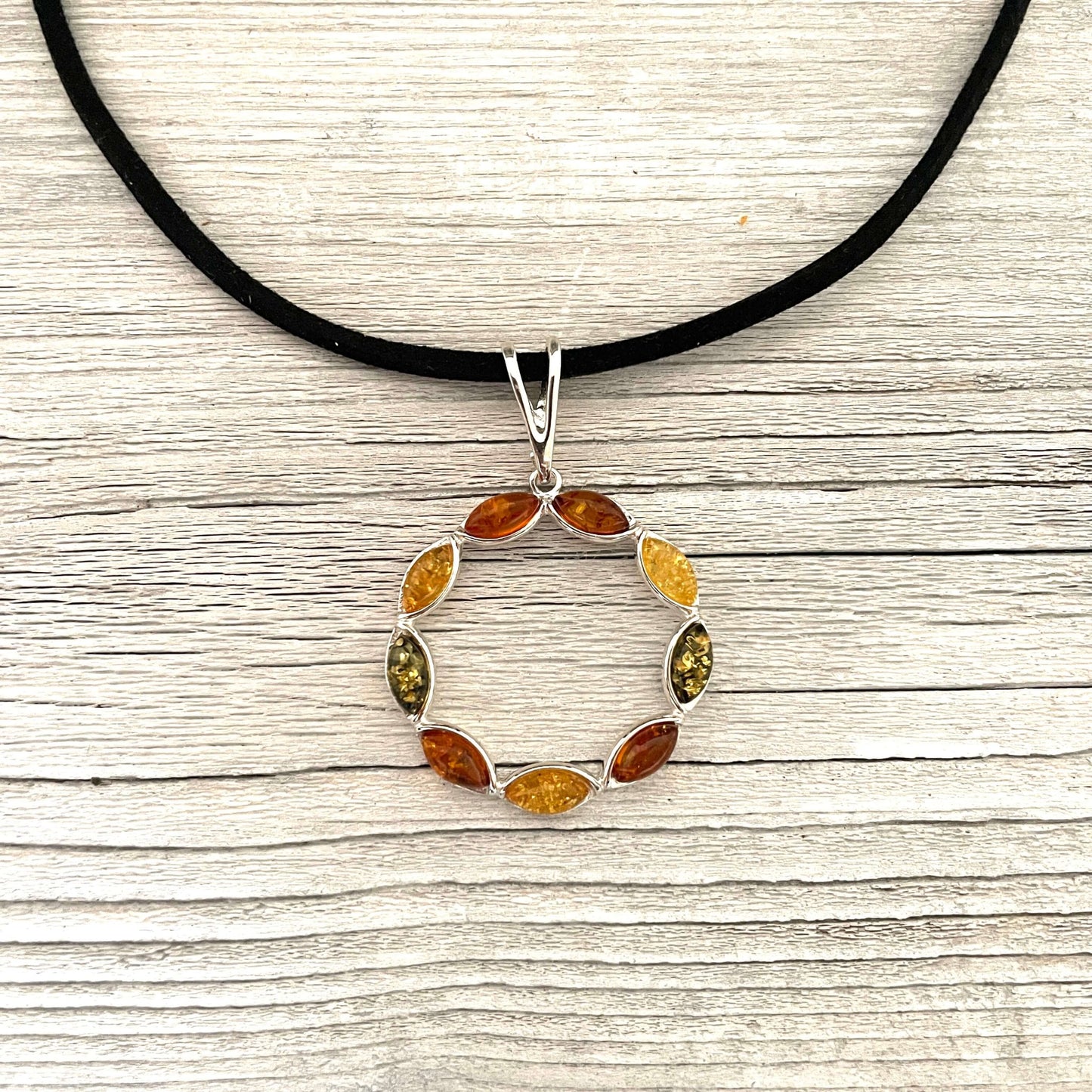 mixed coloured amber pendant set in sterling silver