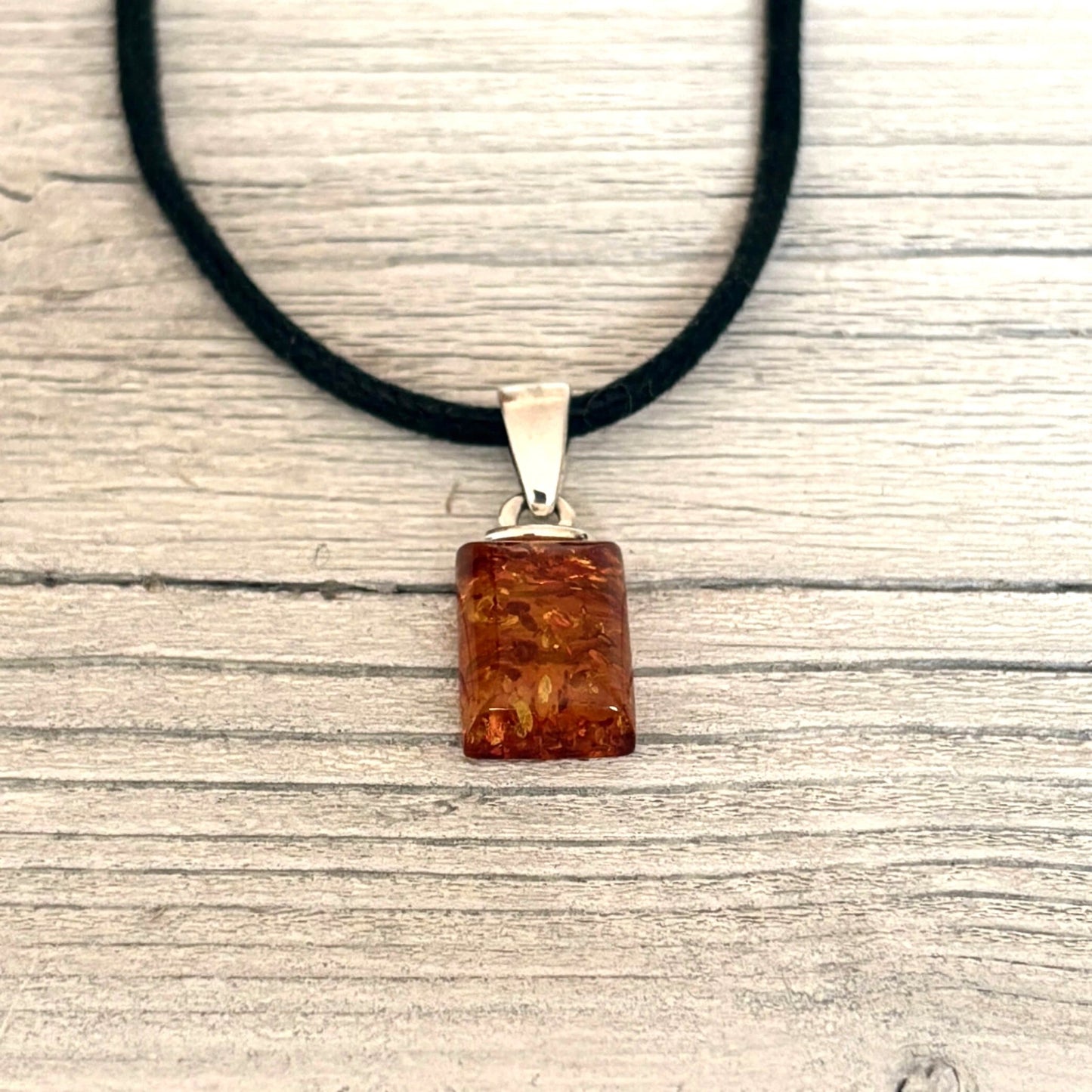 cognac coloured rectangular shaped pendant with sterling silver bail