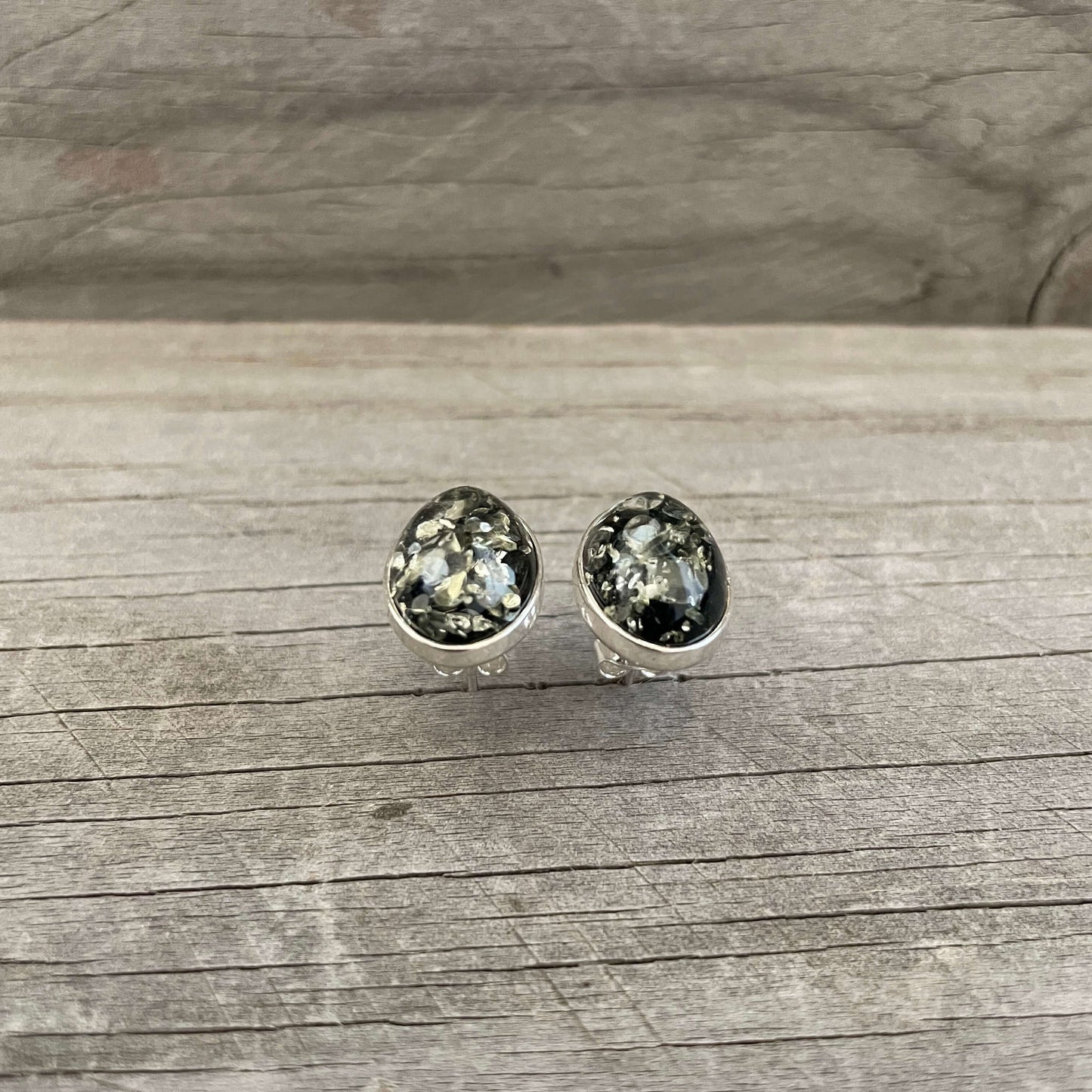 polished oval shaped green amber stud earrings