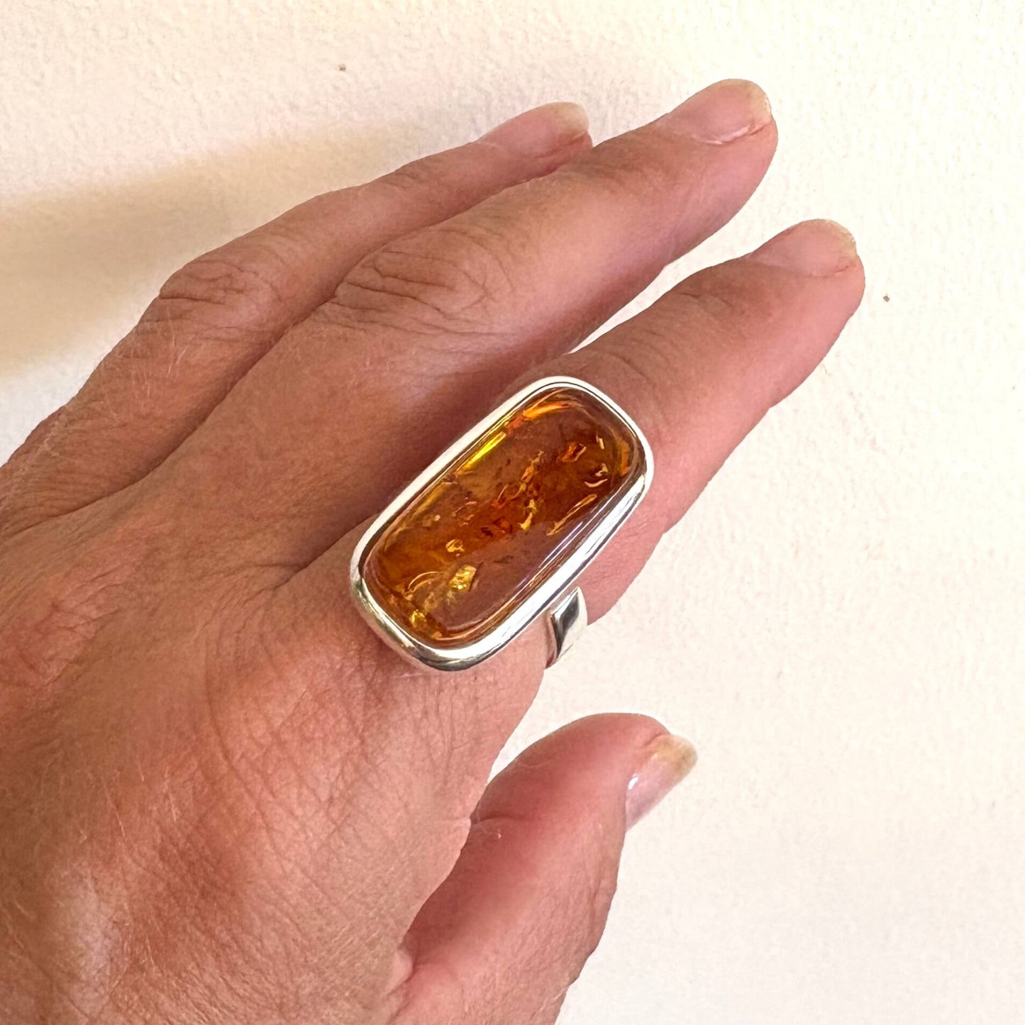 rectangular shaped amber ring on finger