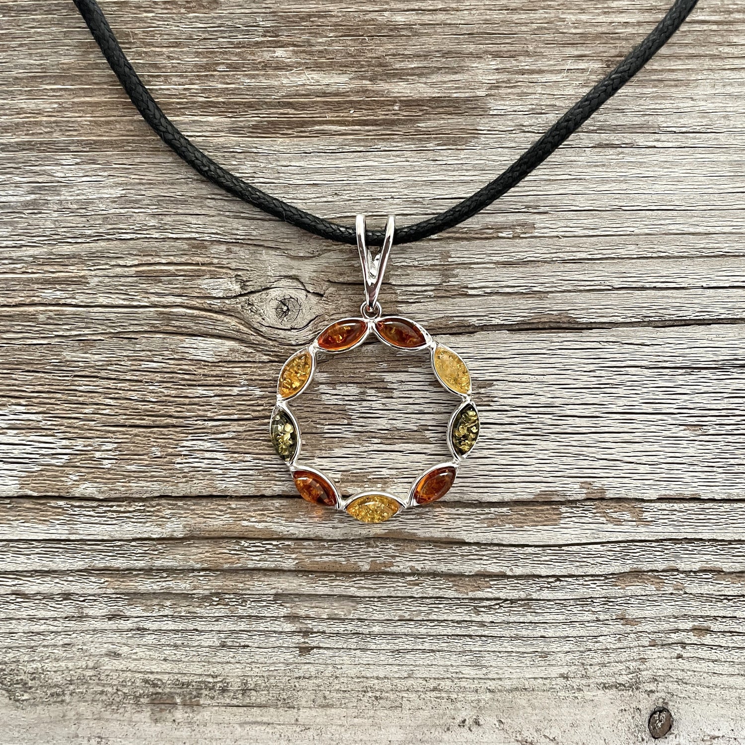 mixed coloured round amber pendant on  black rope