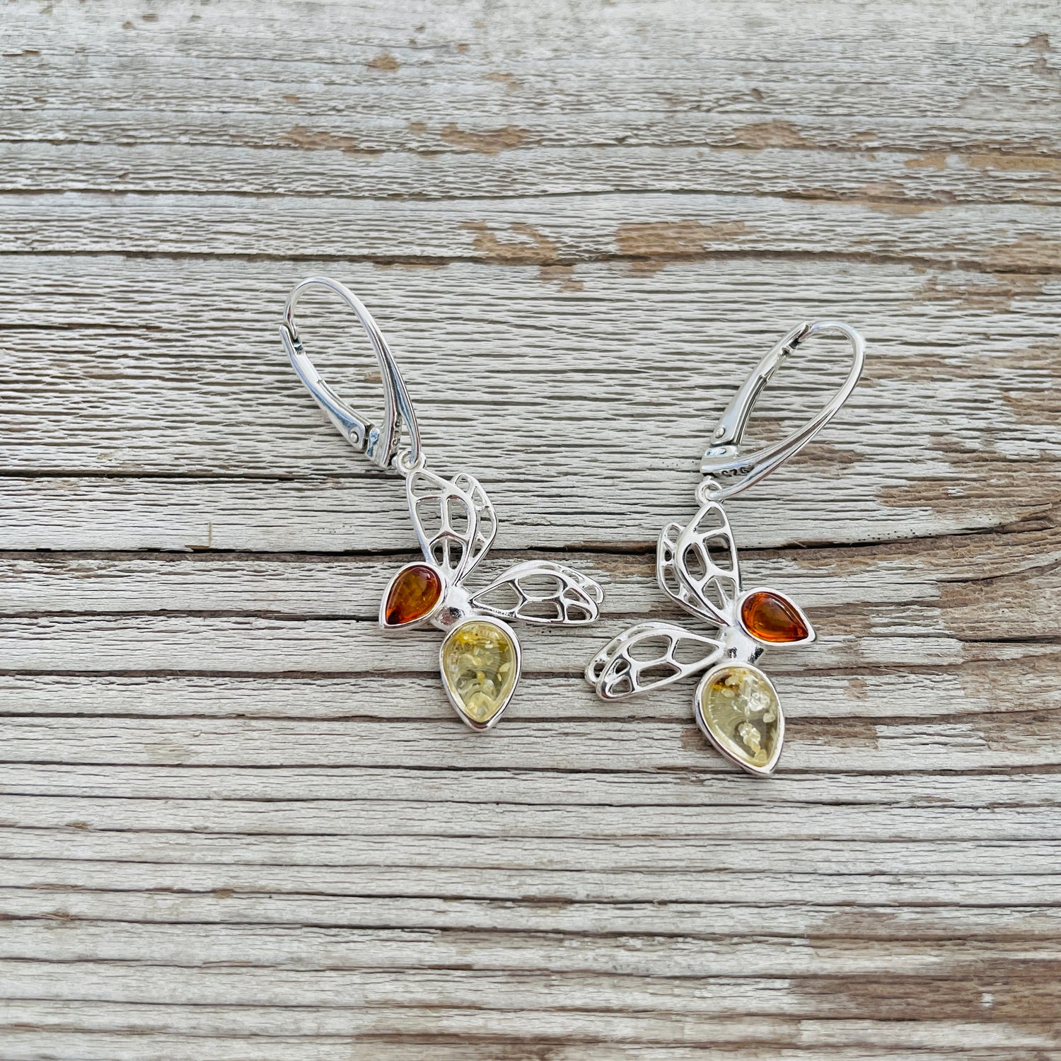cognac and yellow amber set in butterfly shaped sterling silver earrings