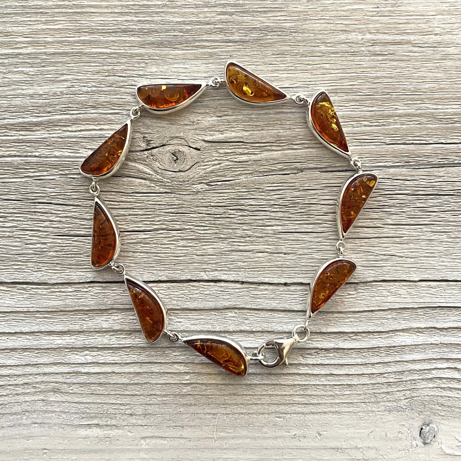 half moon shaped cognac amber set in sterling silver