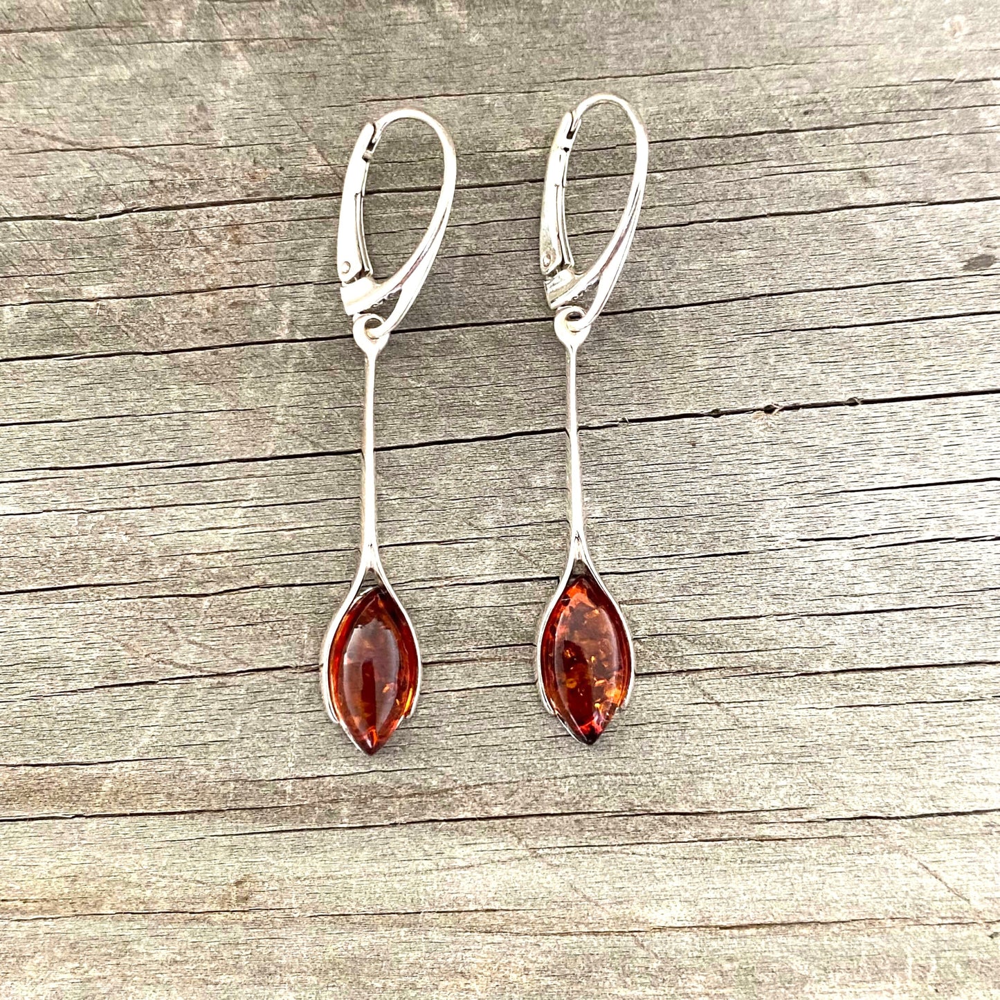 Pair of silver earrings with cognac amber stones