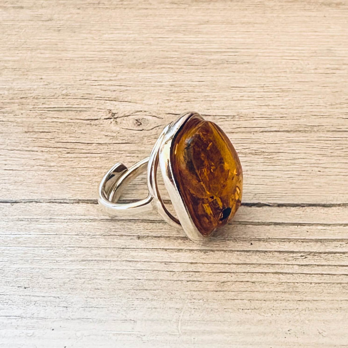 adjustable cognac amber ring set in sterling silver left side
