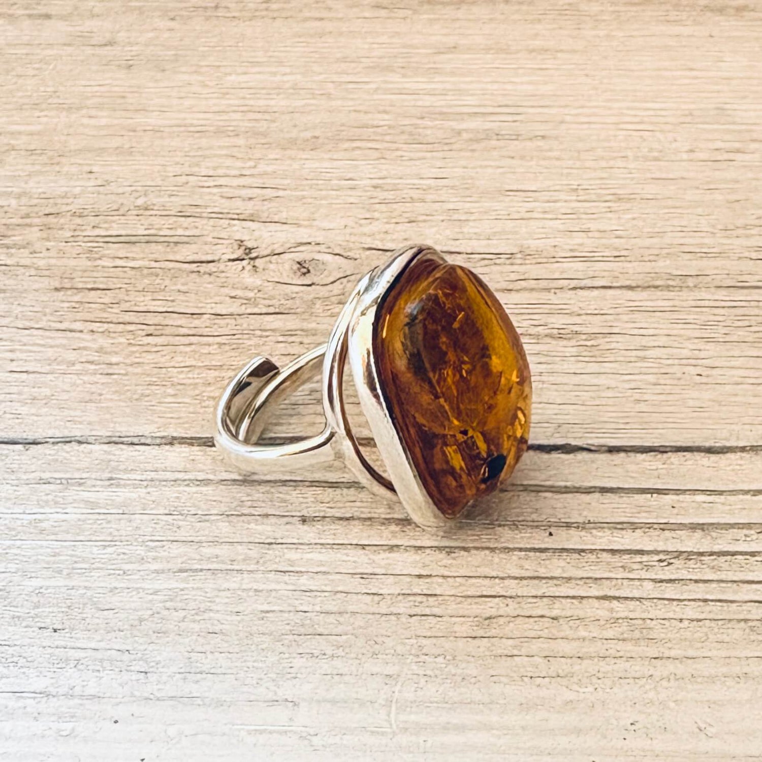 adjustable cognac amber ring set in sterling silver left side