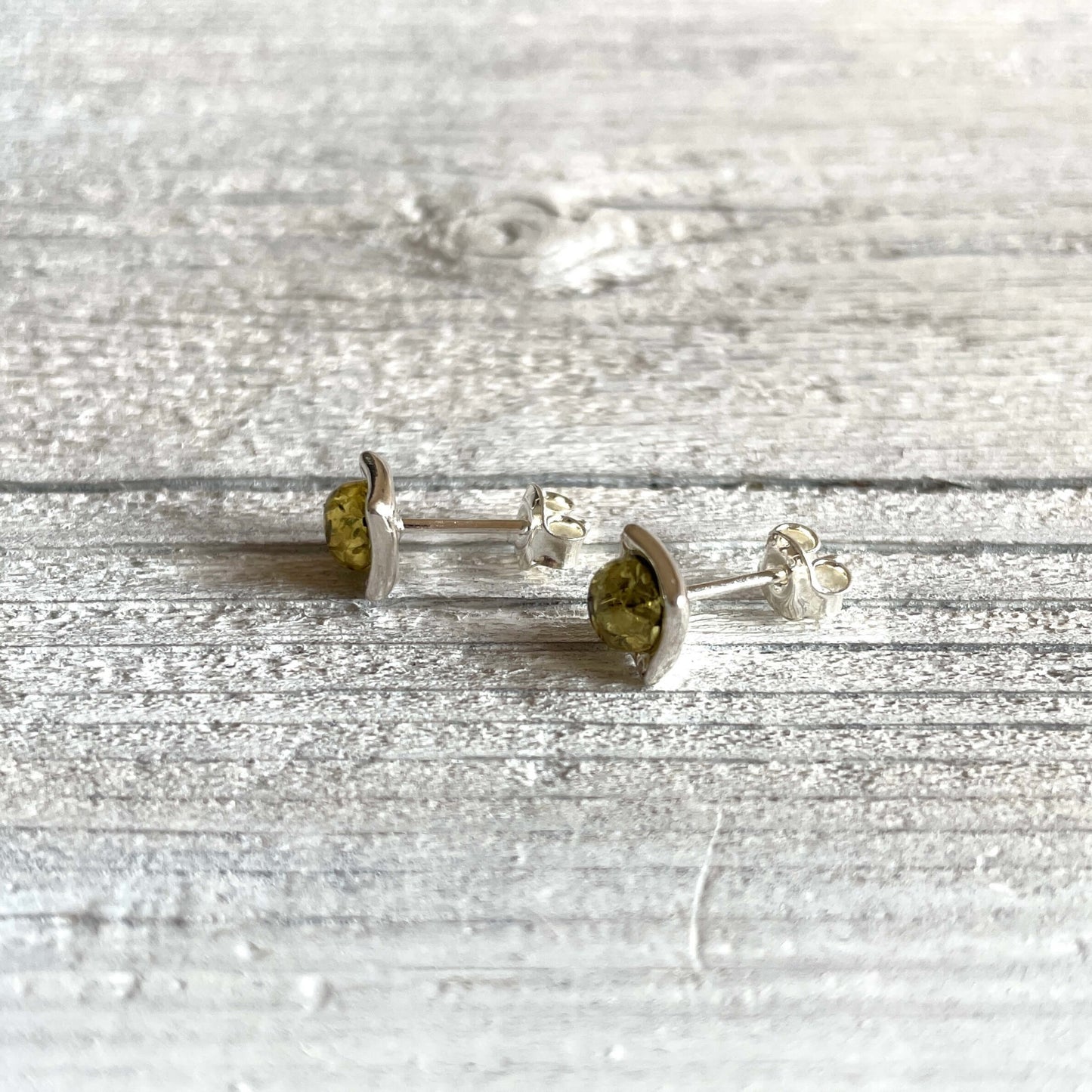 square shaped green amber earrings from the side