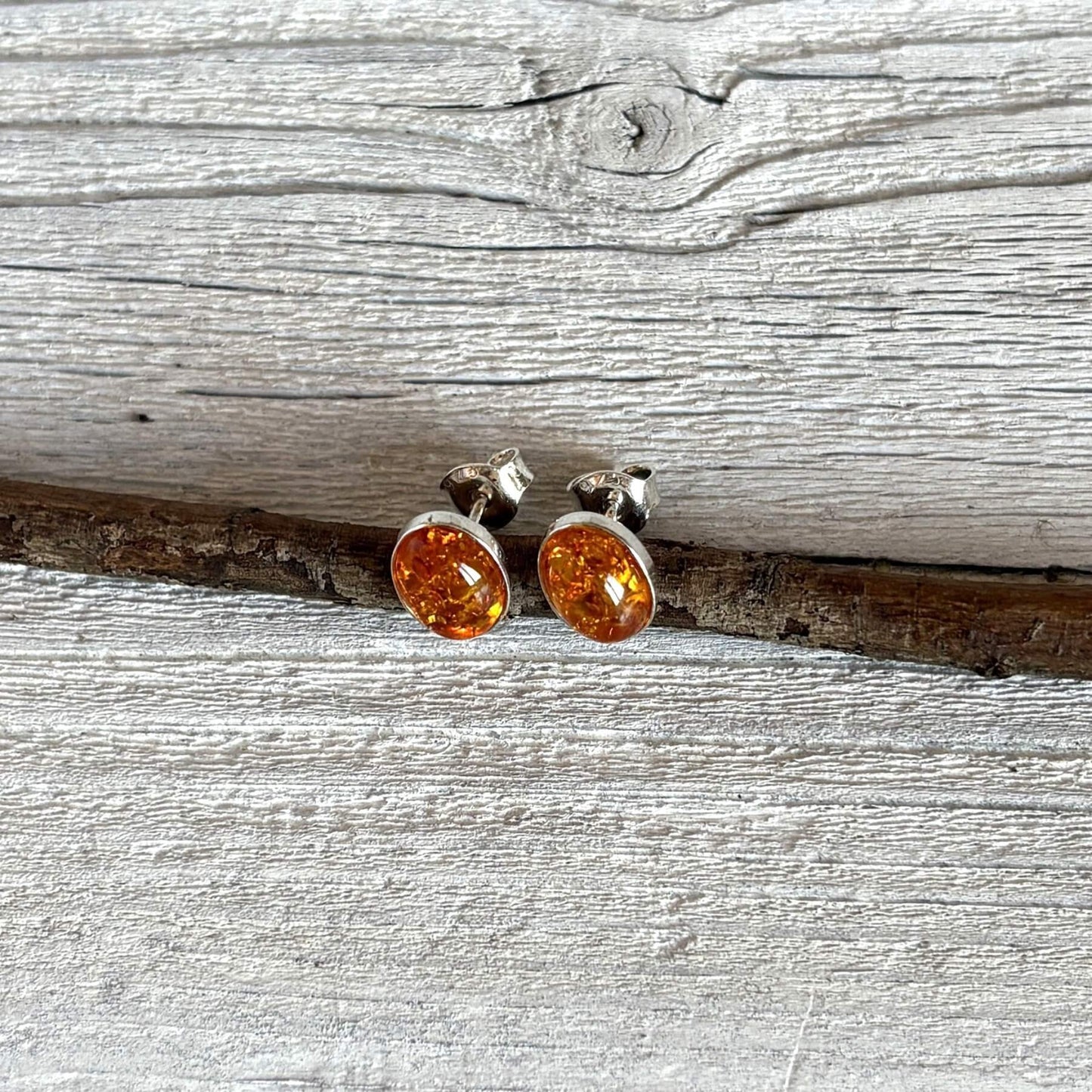 oval shaped cognac amber and silver stud earrings side angle