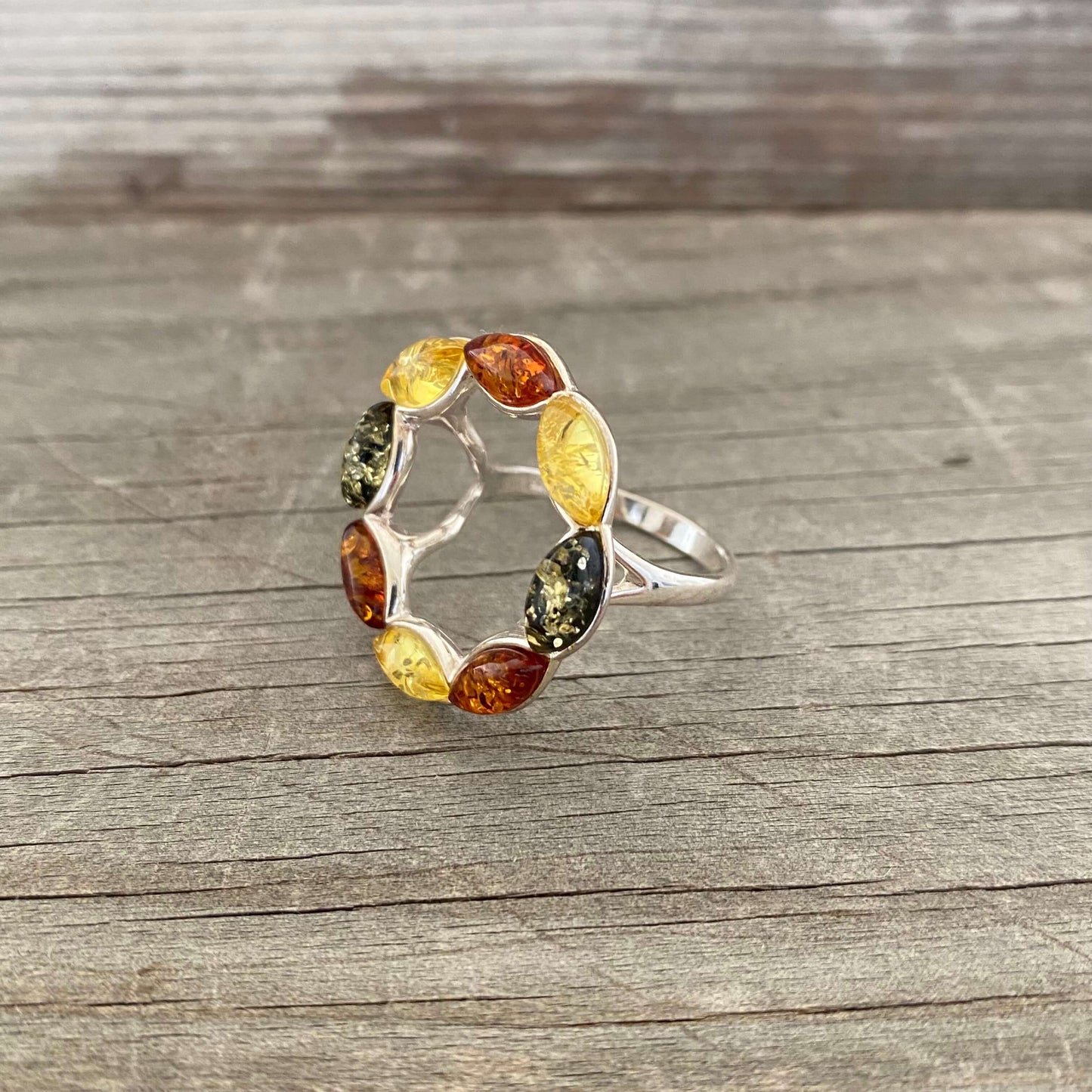 round shaped mixed coloured amber ring set in sterling silver