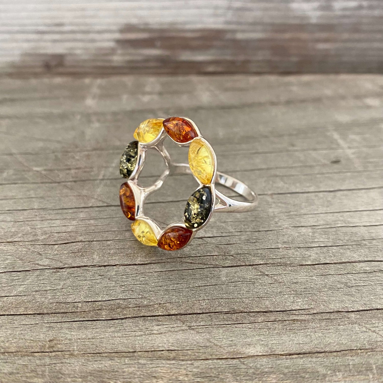 round shaped mixed coloured amber ring set in sterling silver