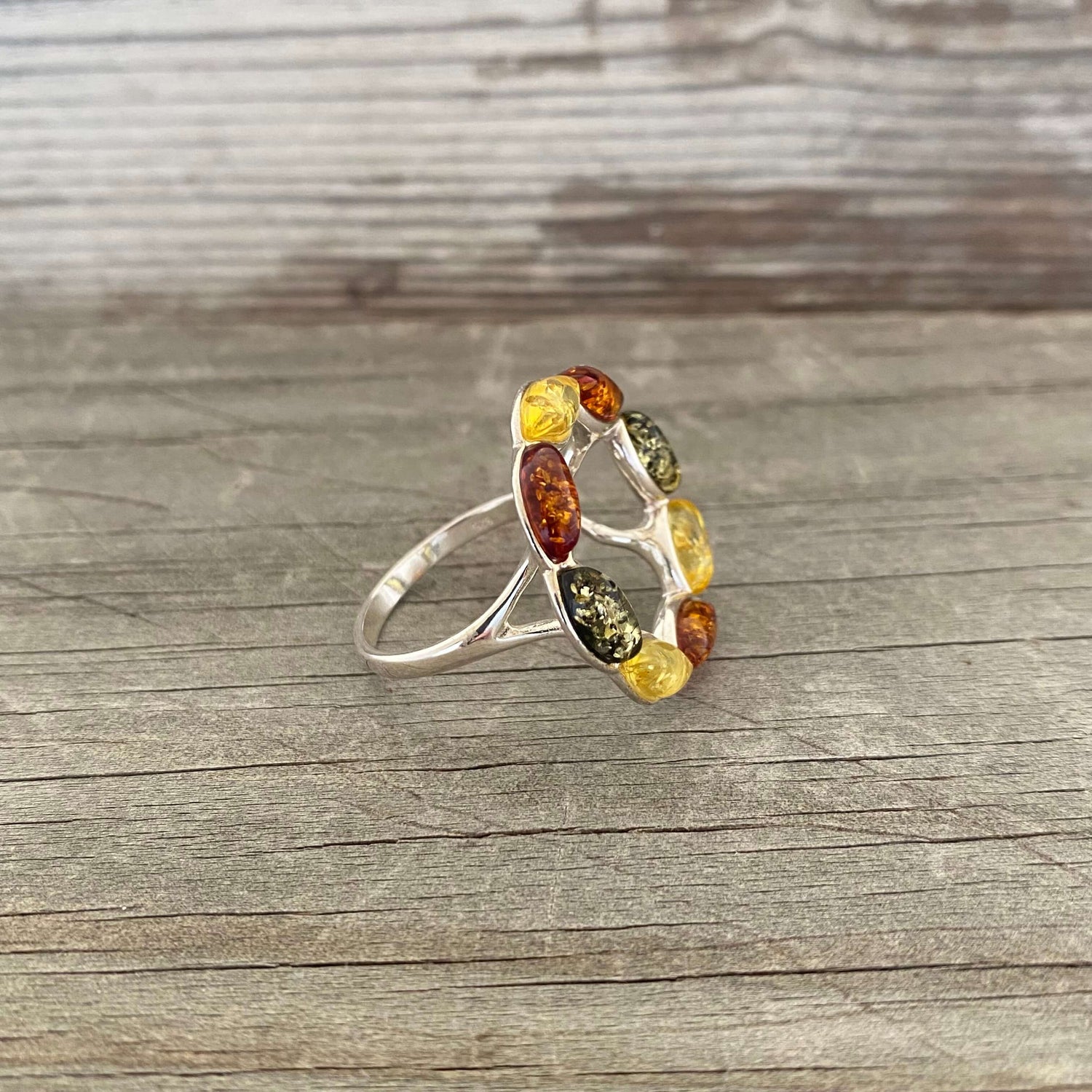 round shaped mixed coloured amber ring set in sterling silver