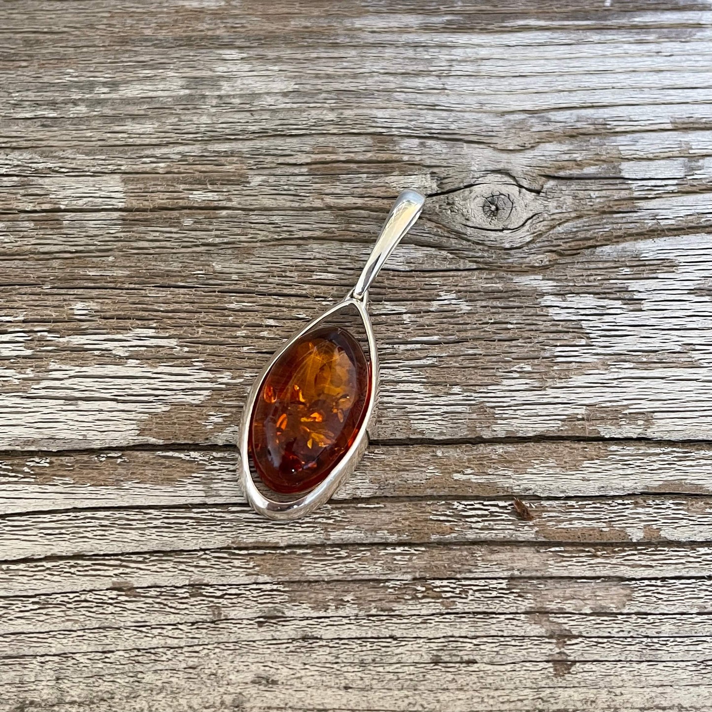 oval shaped cognac amber pendant set in sterling silver