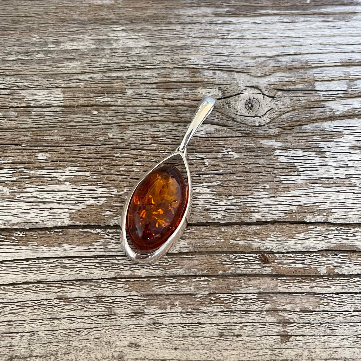 oval shaped cognac amber pendant set in sterling silver