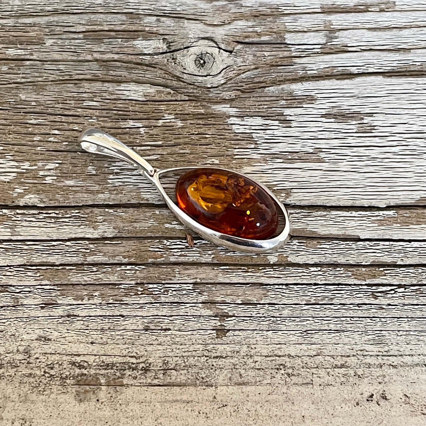 oval shaped cognac amber pendant set in sterling silver