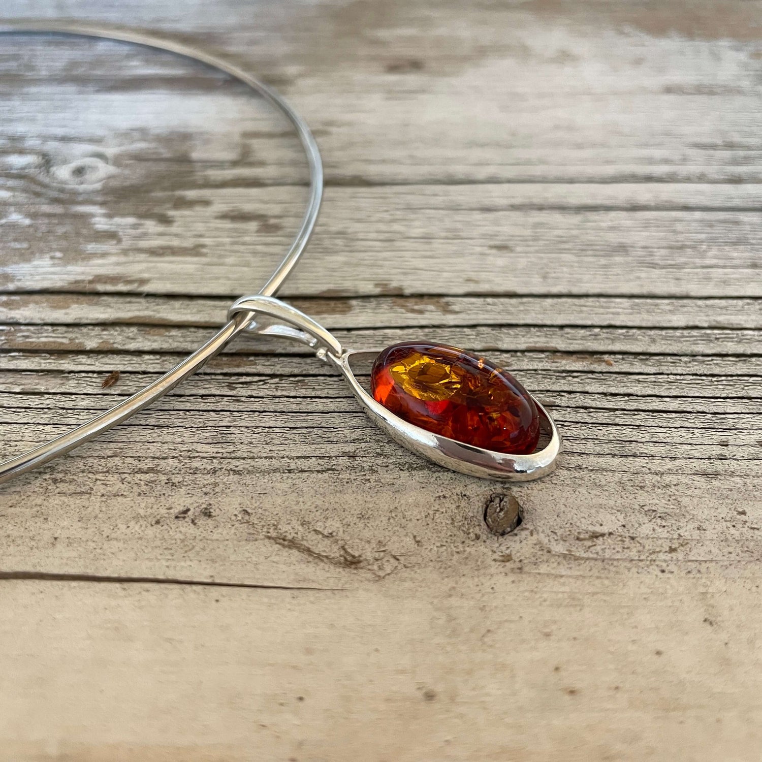 oval shaped cognac amber pendant set in sterling silver