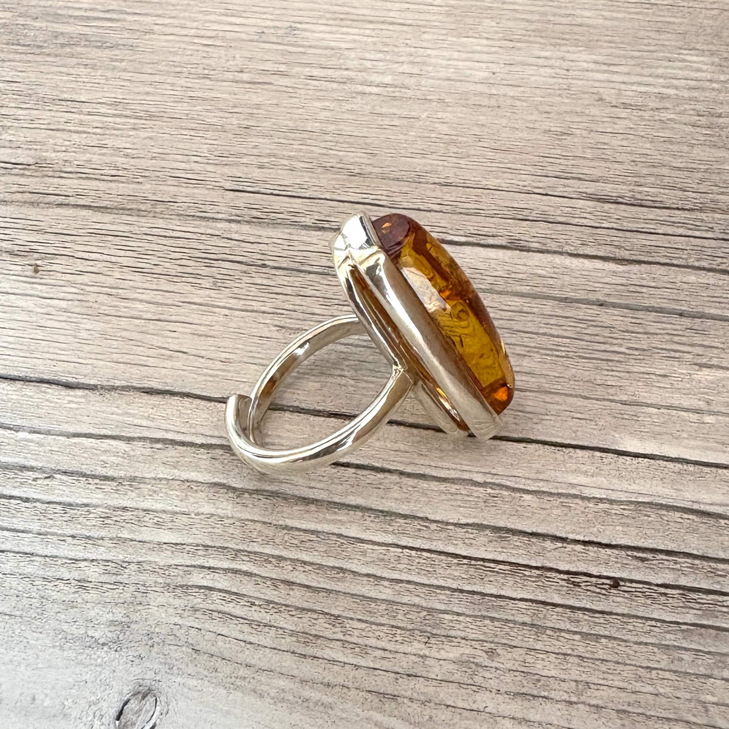 side picture of a sterling silver and rectangular amber adjustable ring