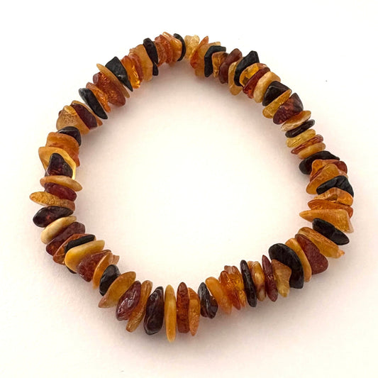 Multicolored polished beaded bracelet on a white background