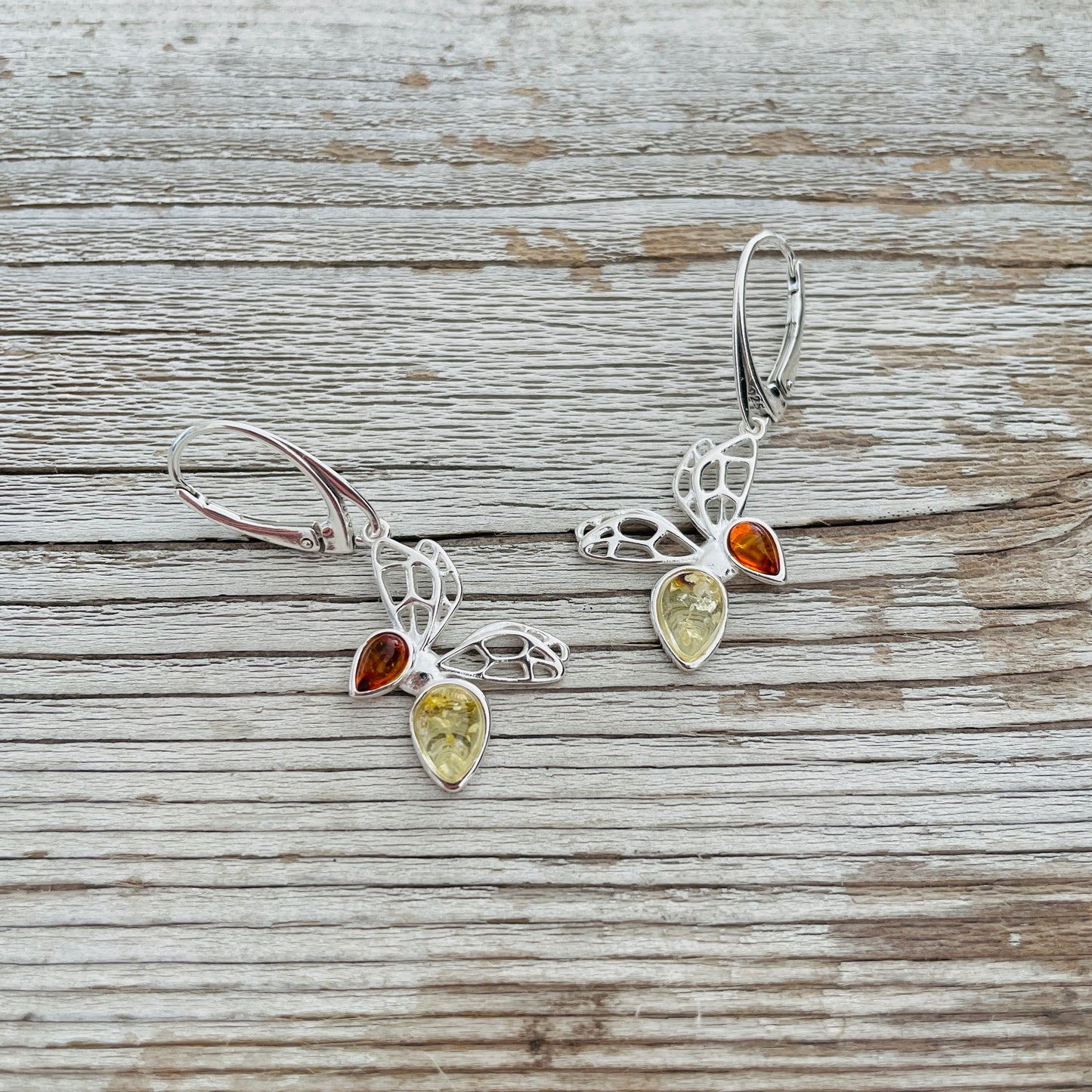 cognac and yellow amber set in butterfly shaped sterling silver earrings