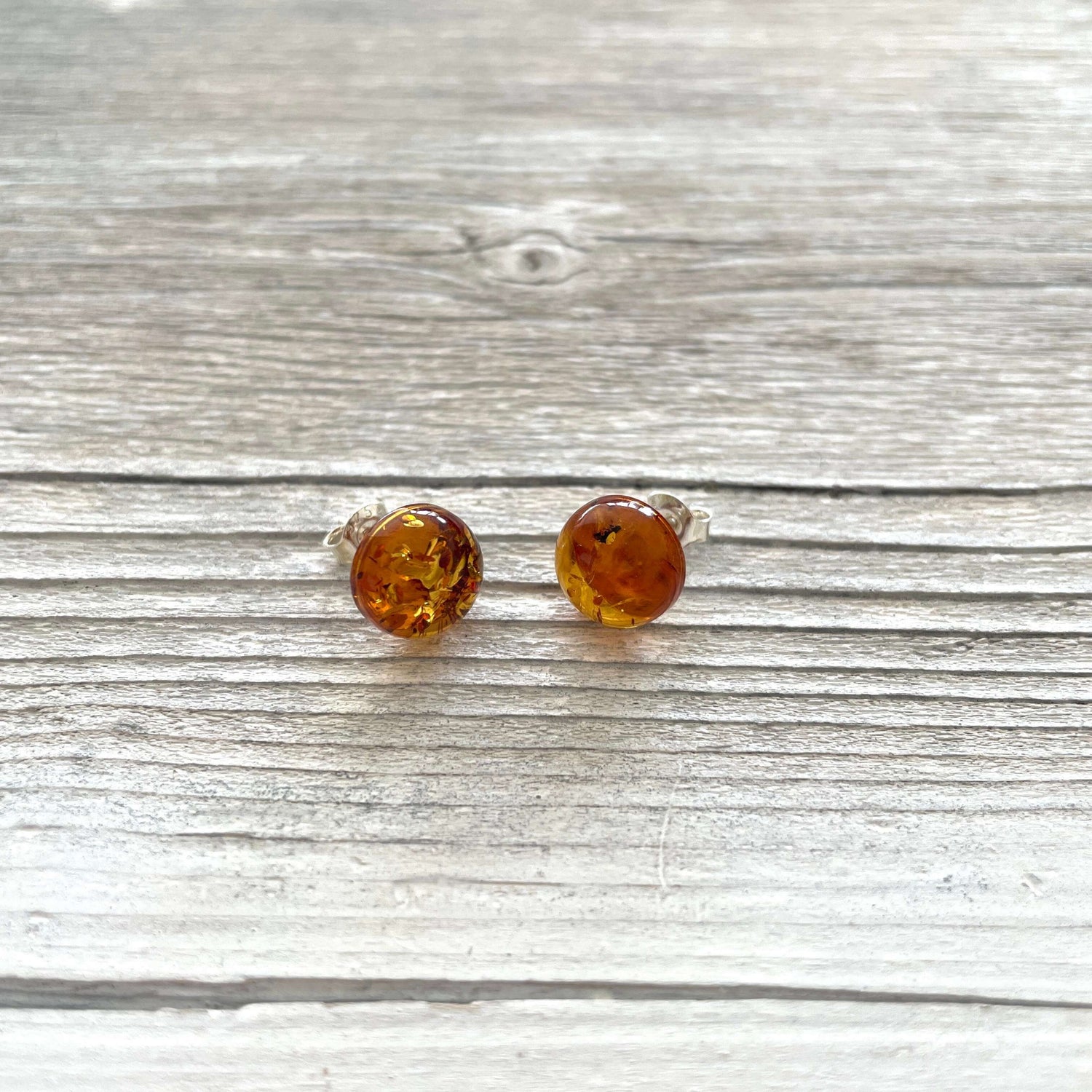 round amber polished stud earrings