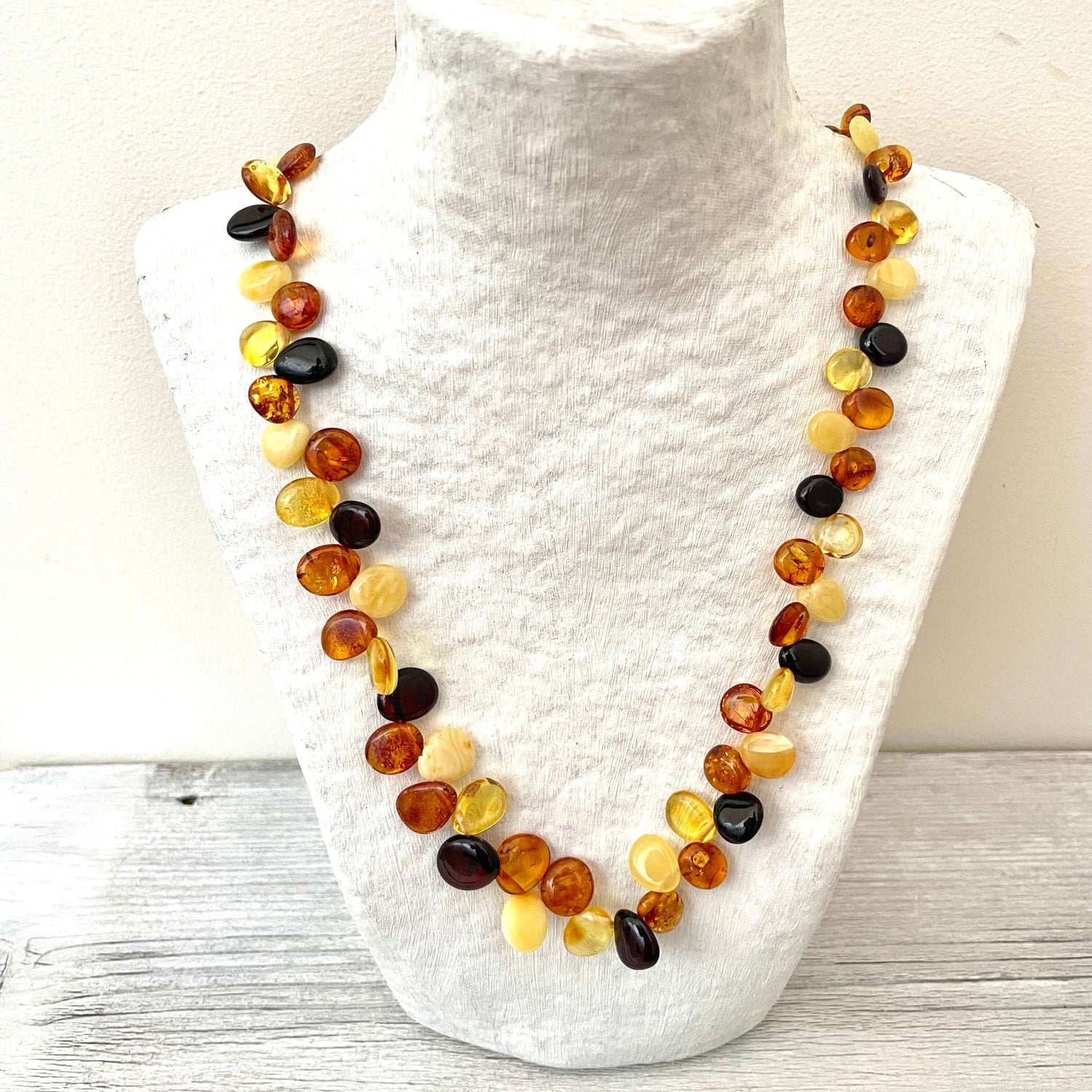 polished mixed colored amber necklace with screw clasp