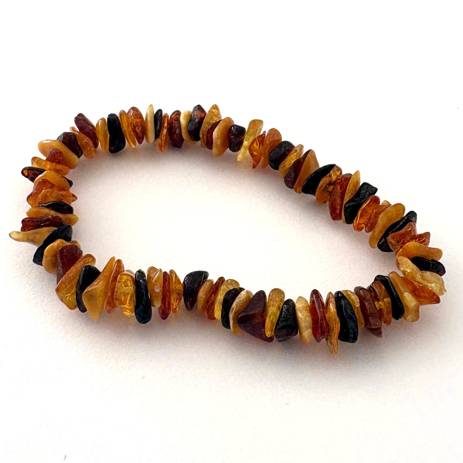 Multicolored amber bracelet on a white background