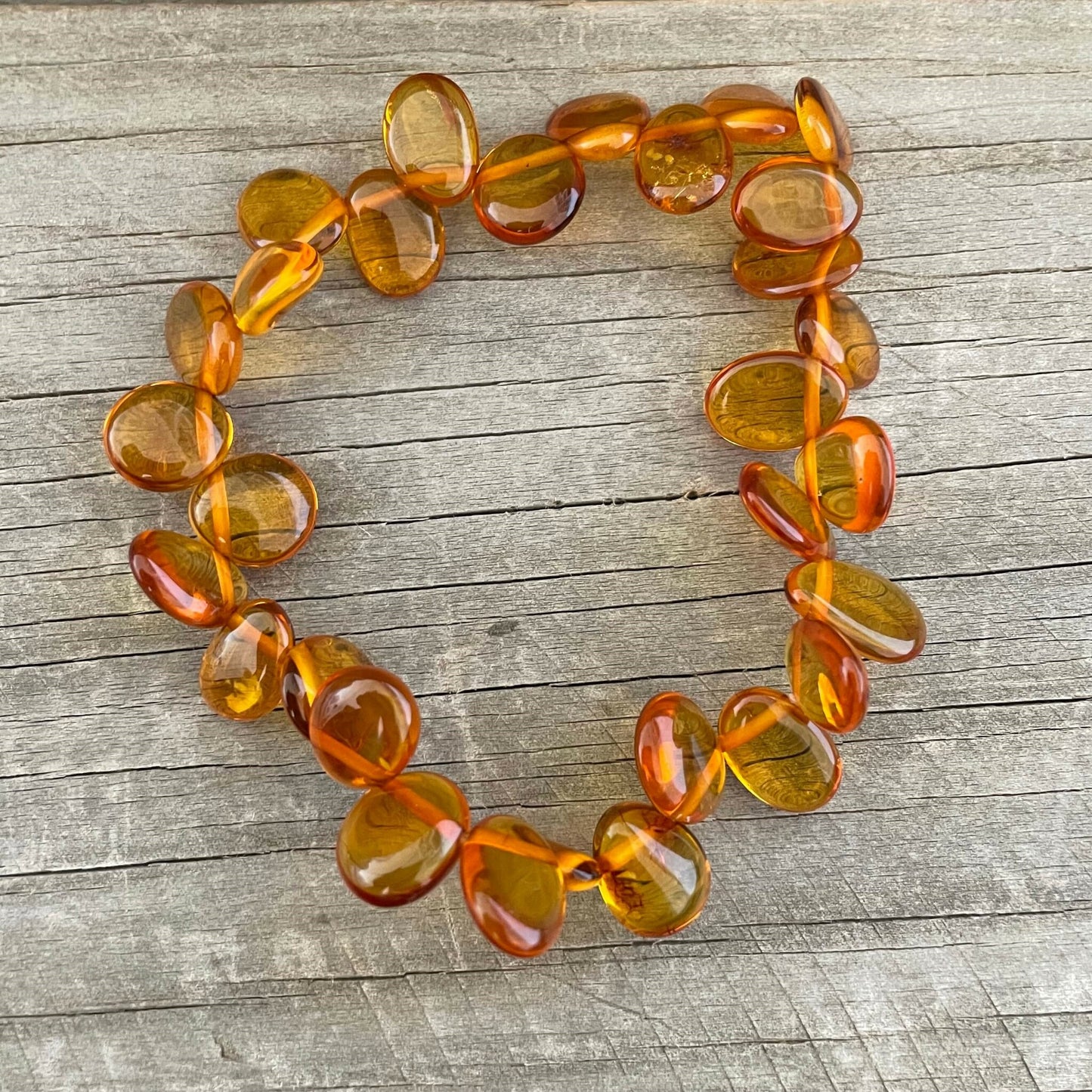 honey coloured beaded amber bracelet on elastic