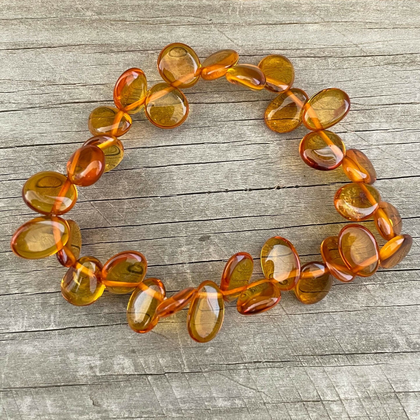 honey coloured beaded amber bracelet on wood