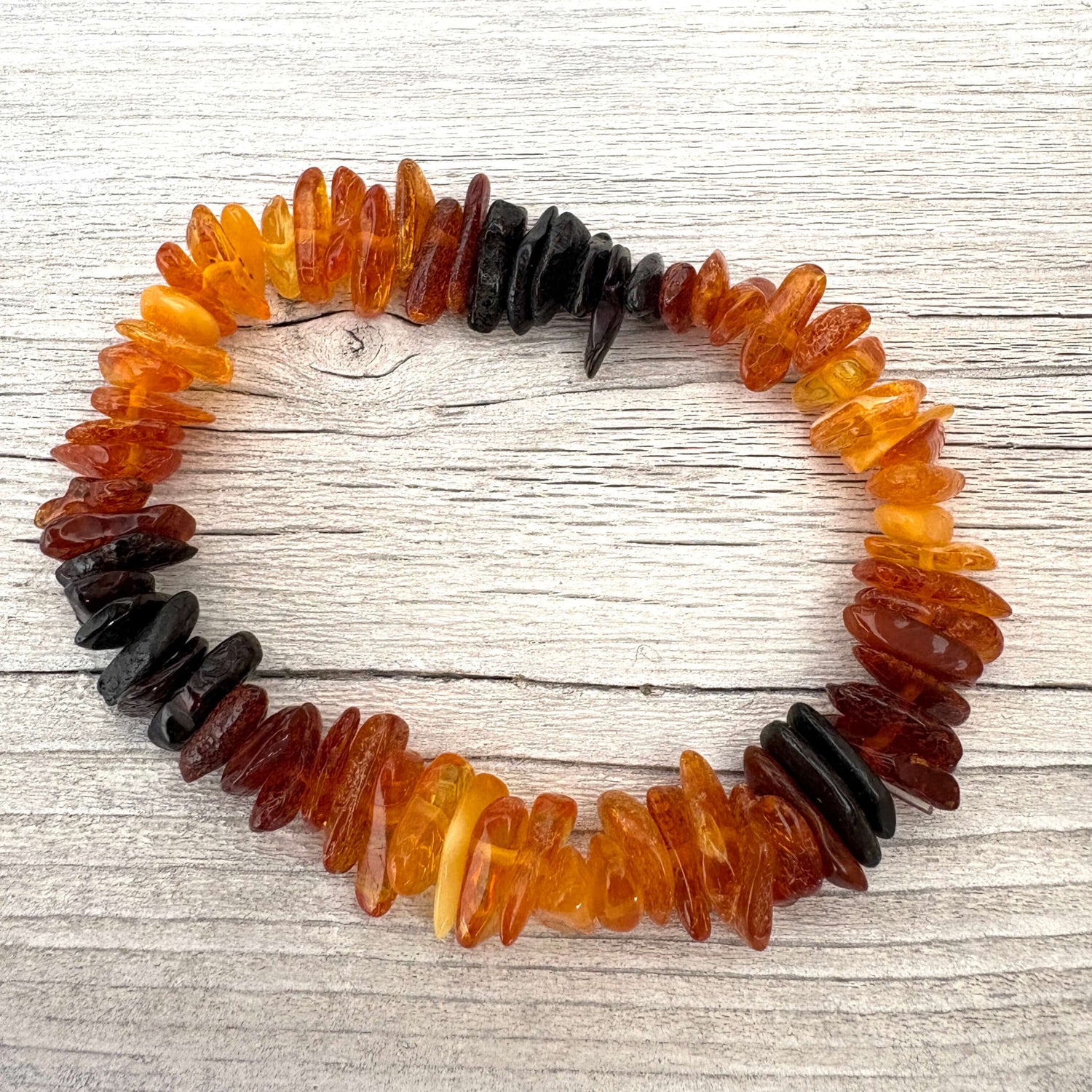 Bracelet made of amber beads on a wooden surface