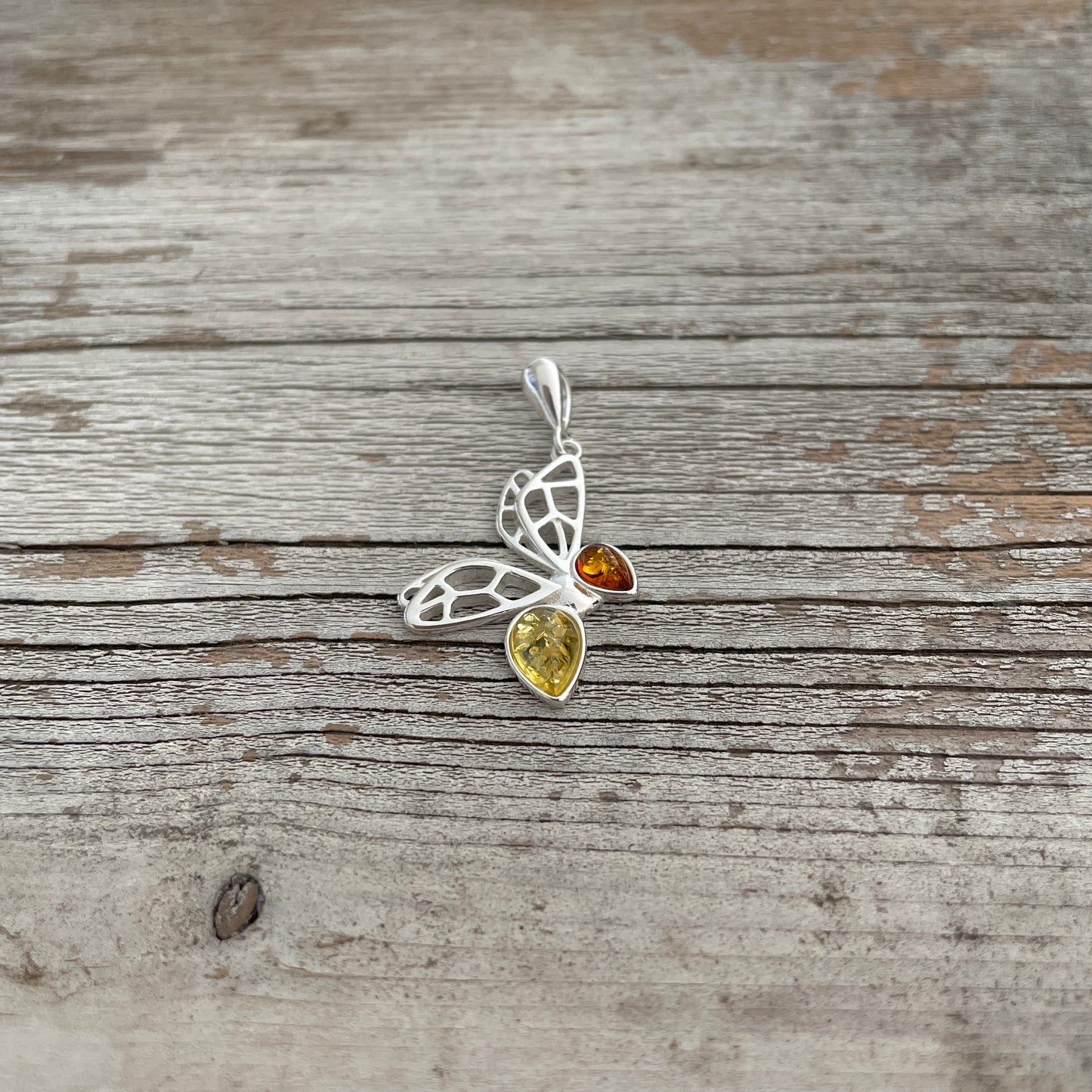 sterling silver butterfly shape with yellow and cognac amber stones