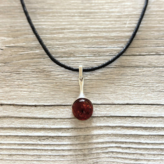 Sterling silver pendant featuring genuine cognac Baltic amber.