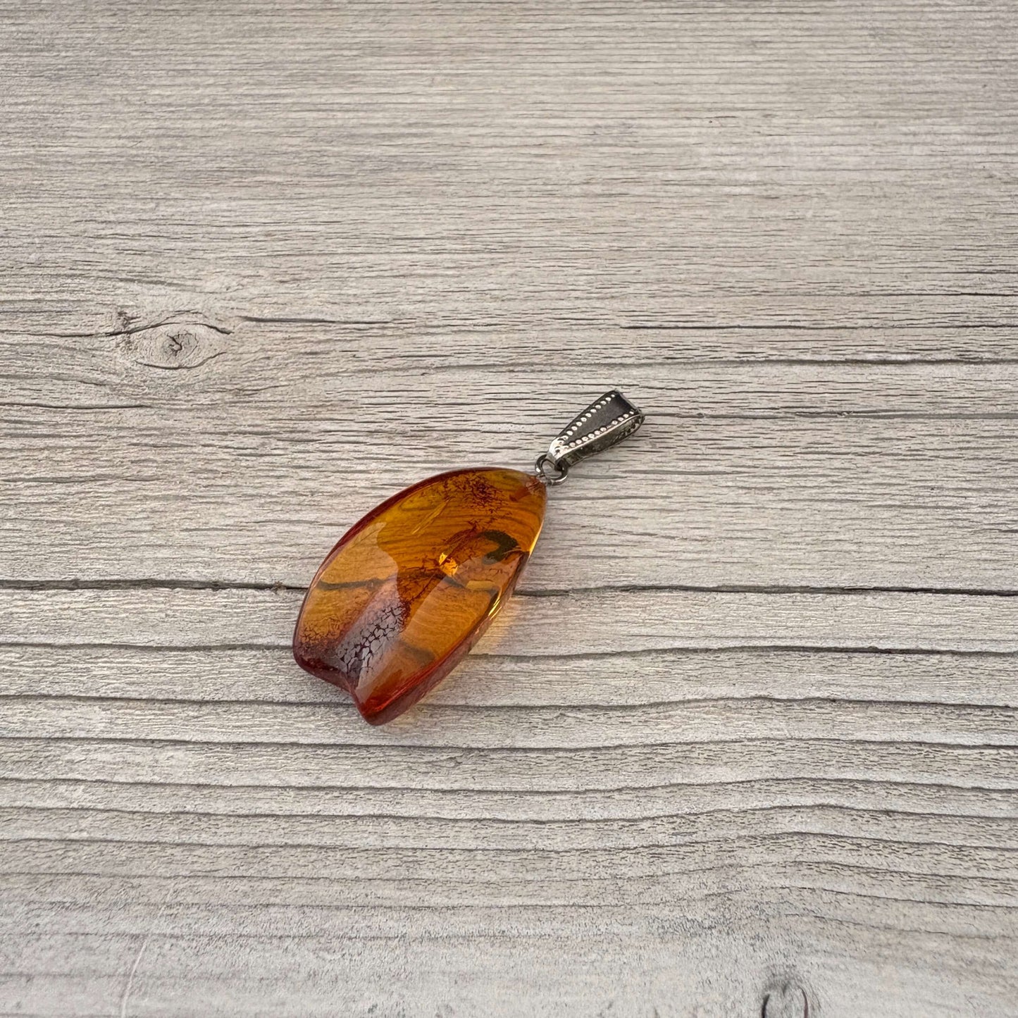 Baltic amber pendant with silver link on side