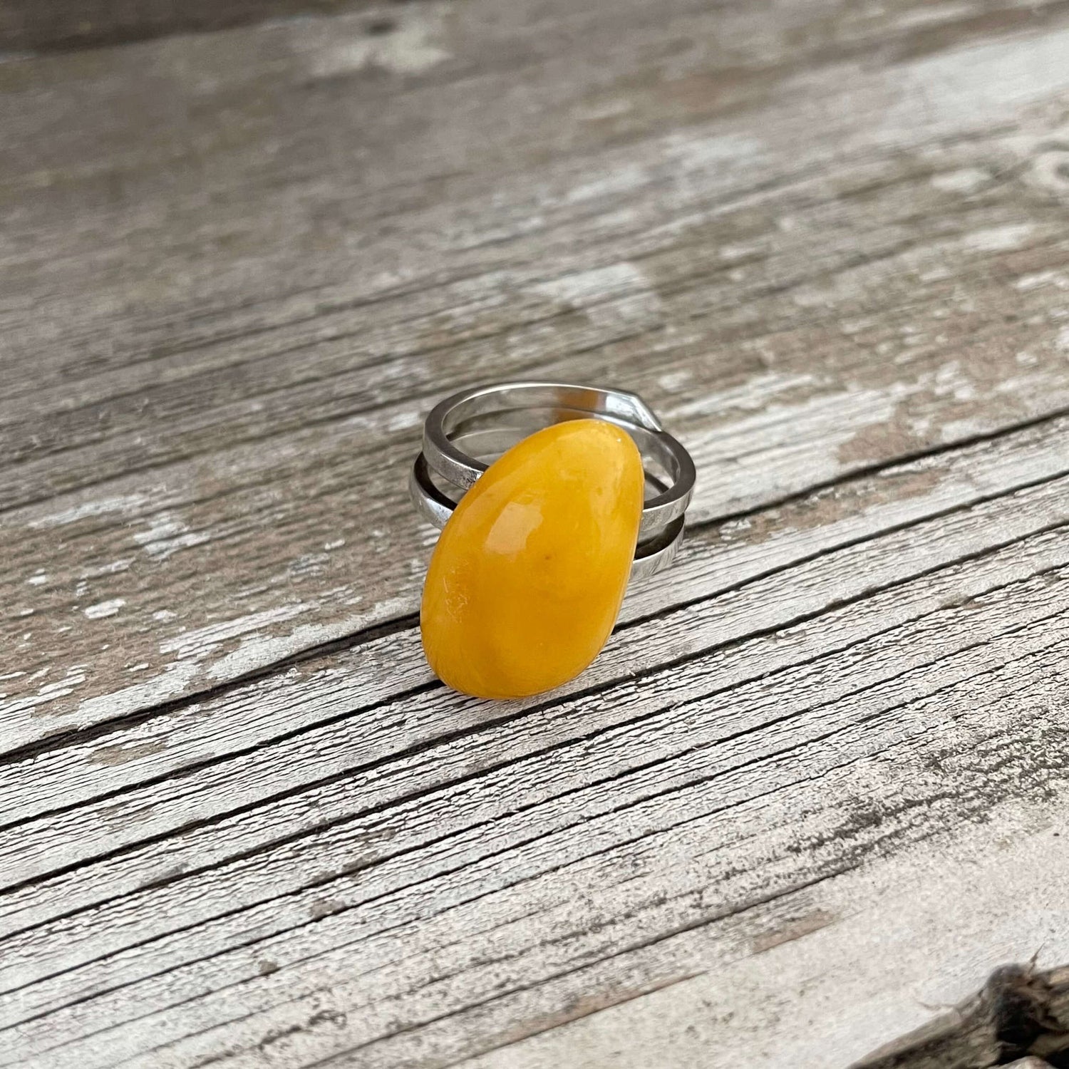 yellow amber adjustable ring on a sterling silver band