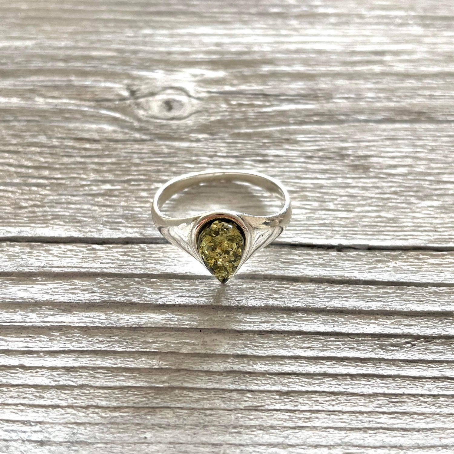 tear drop shaped green amber ring set in sterling silver