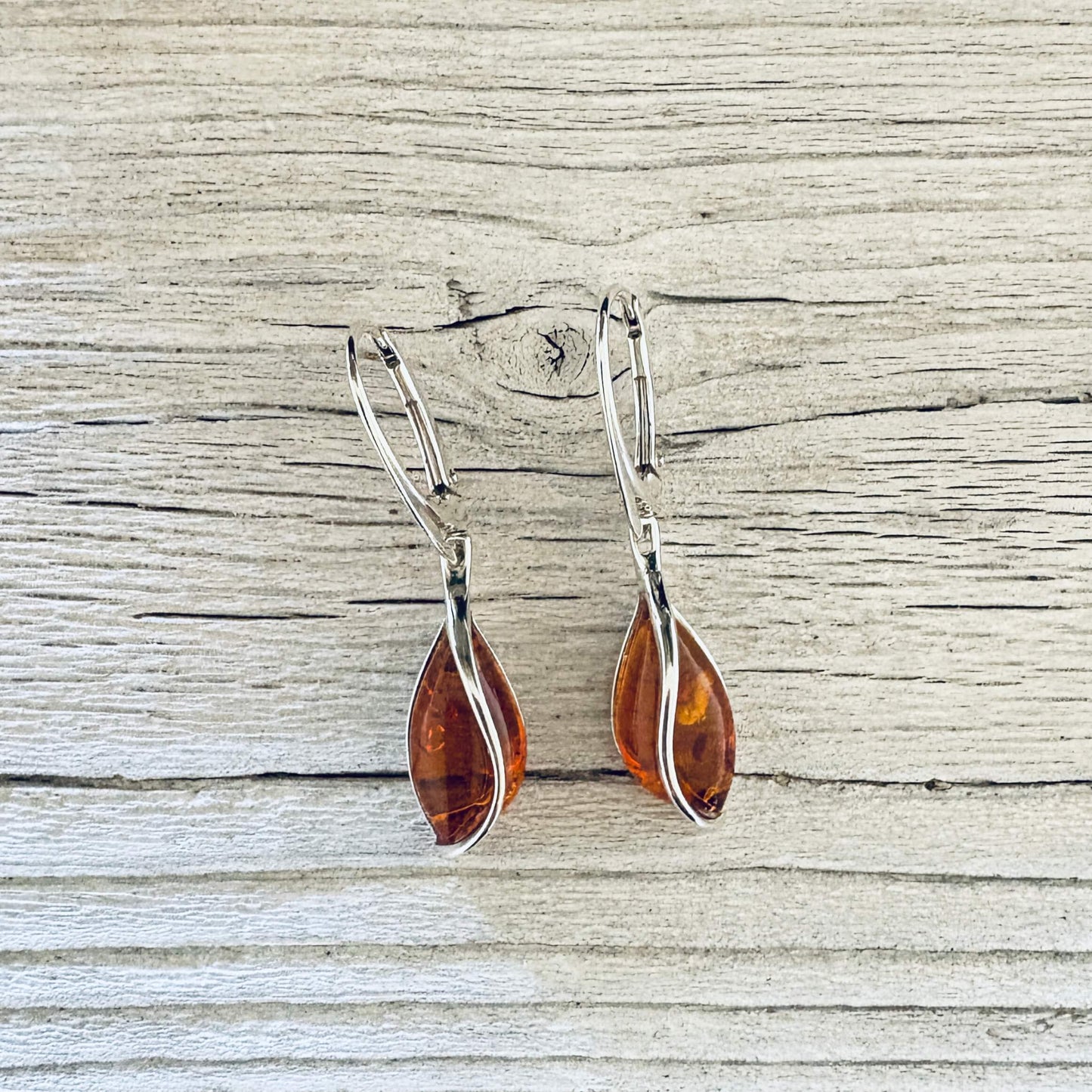Cognac Baltic amber drop earrings with sterling silver twist settings and lever back hooks.