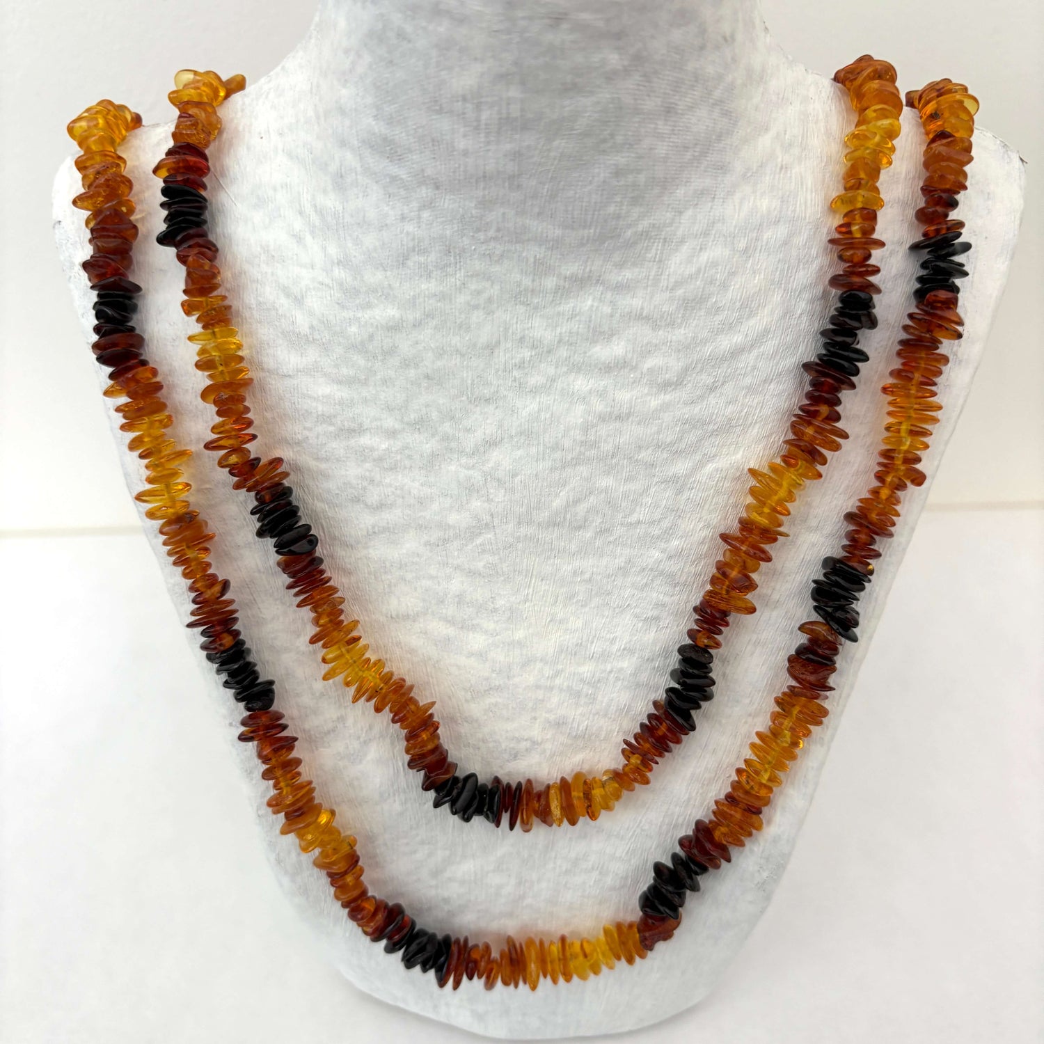 Amber beaded necklace on a white  plain background