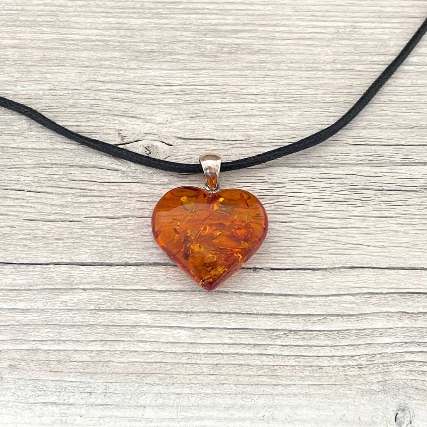 cognac coloured lover heart shaped amber pendant front