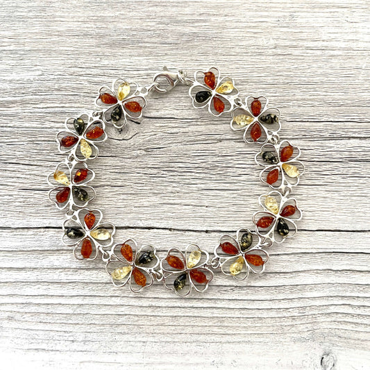mixed coloured flower shaped amber bracelet set in sterling silver with lobster claw