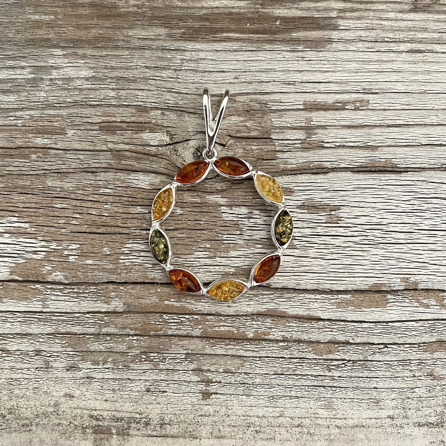 mixed coloured amber pendant set in sterling silver